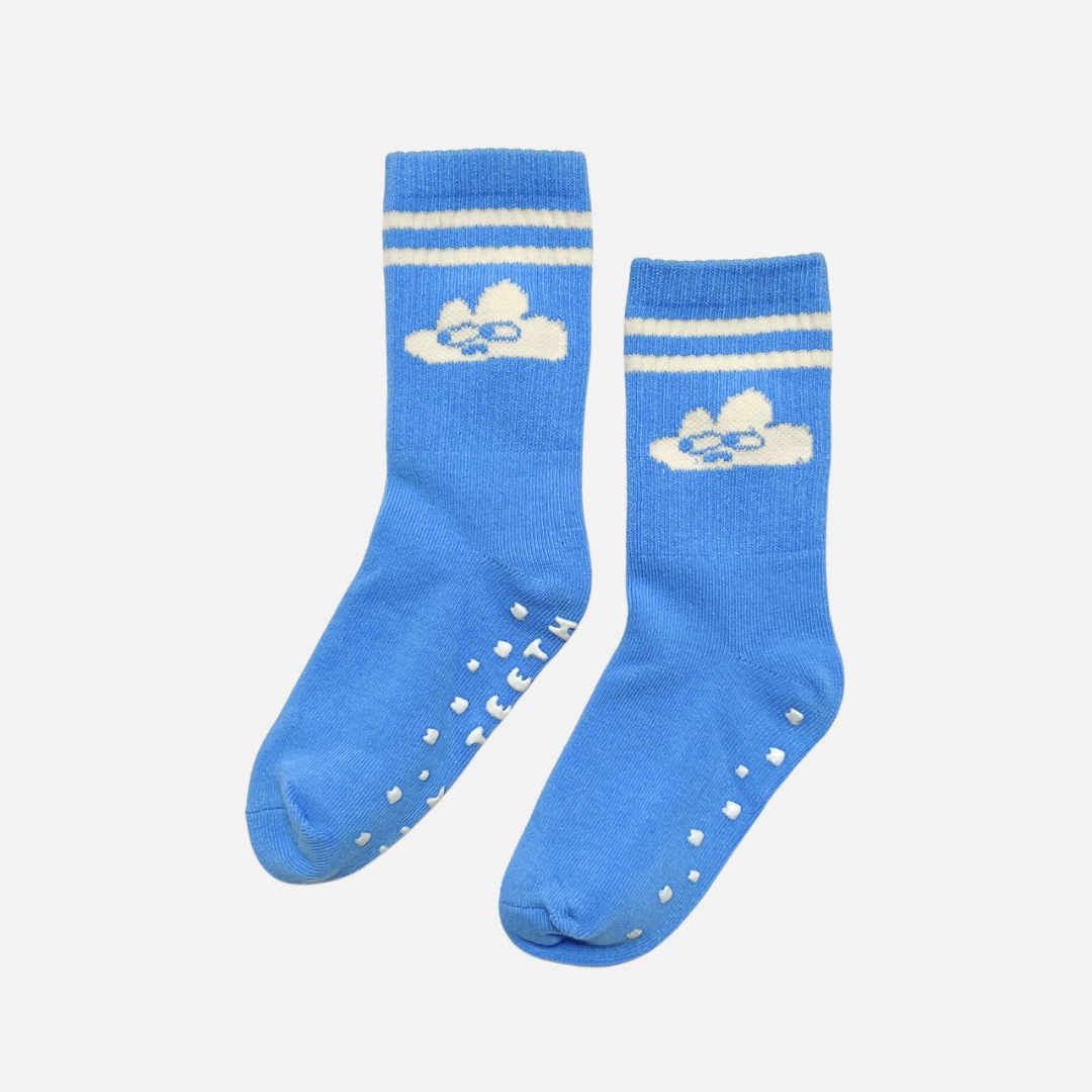 Pair of blue socks with white stripes and cloud design on a light gray background