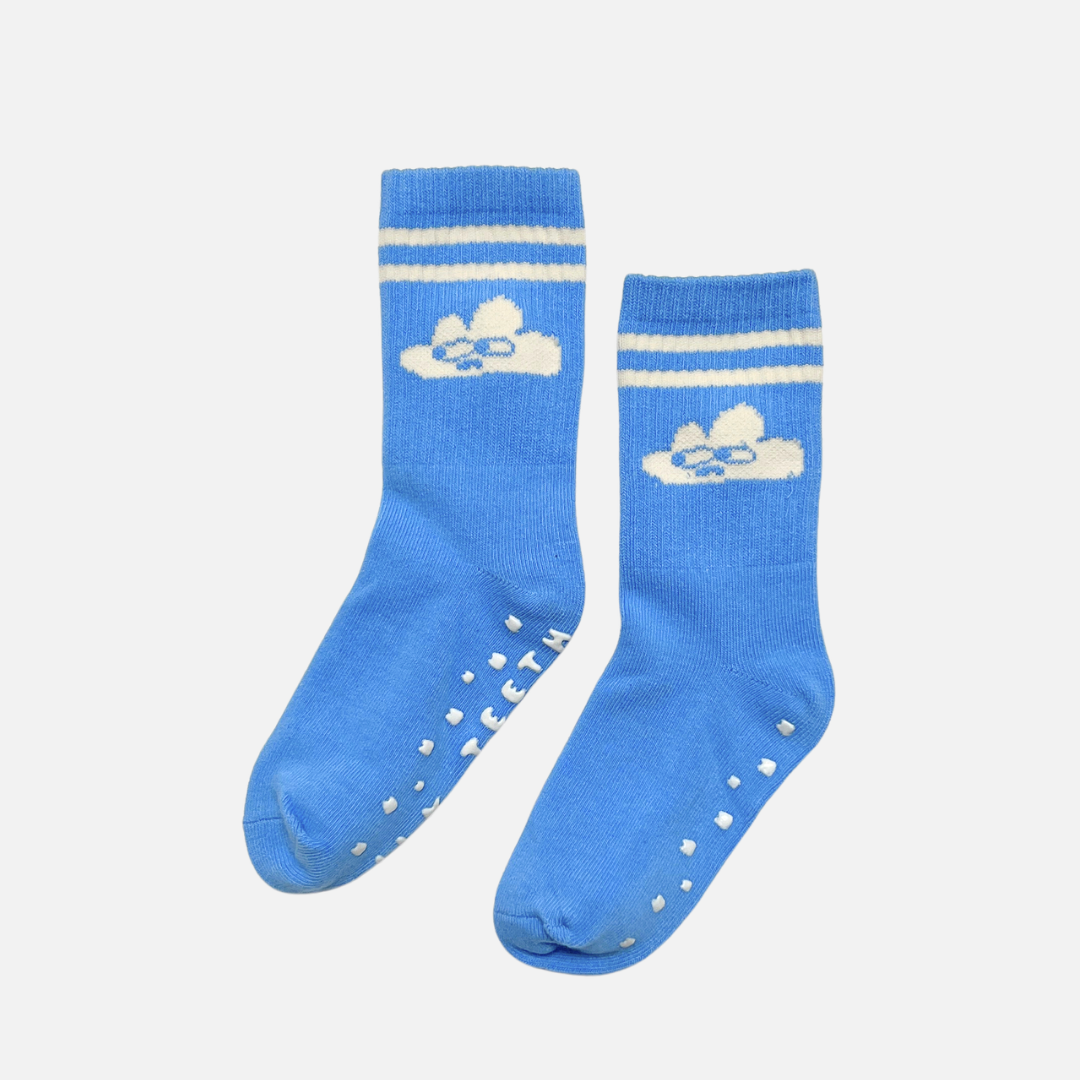 Pair of blue socks with white stripes and cloud design on a light gray background