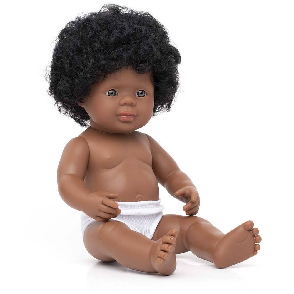 Doll with curly black hair and a diaper on a white background