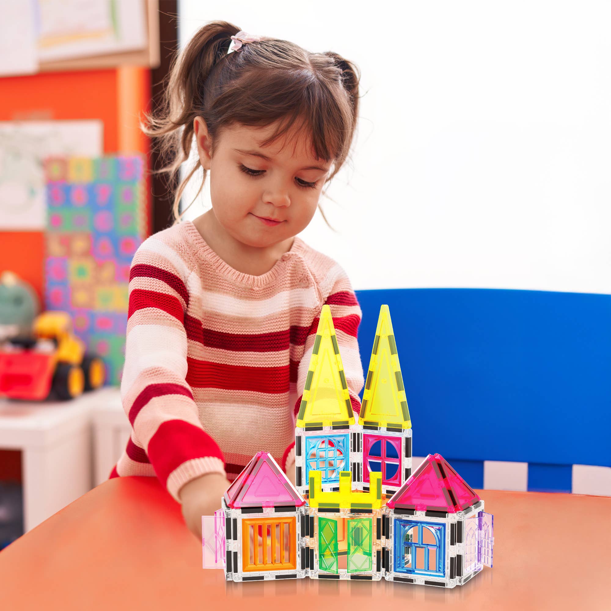 Child playing with colorful building blocks at a table