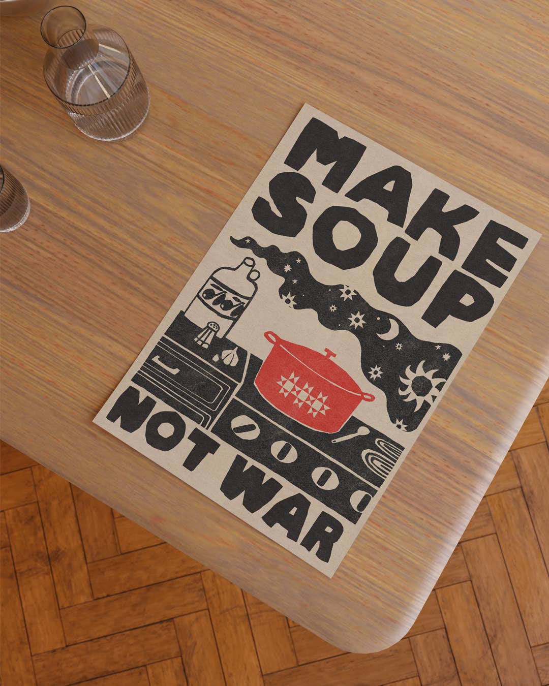 Poster with 'Make Soup Not War' text on a wooden table.