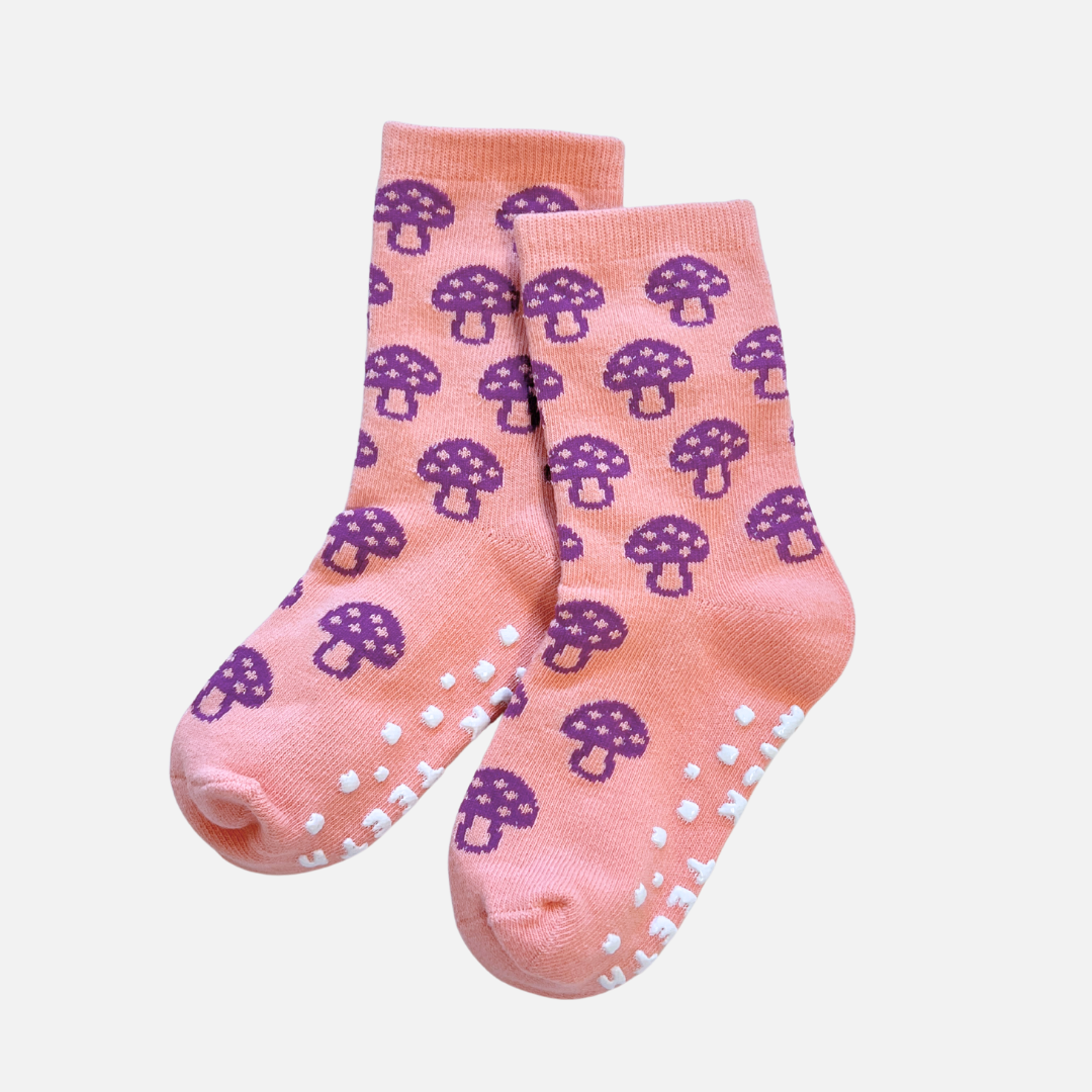 Pink socks with purple mushroom pattern on a light pink background