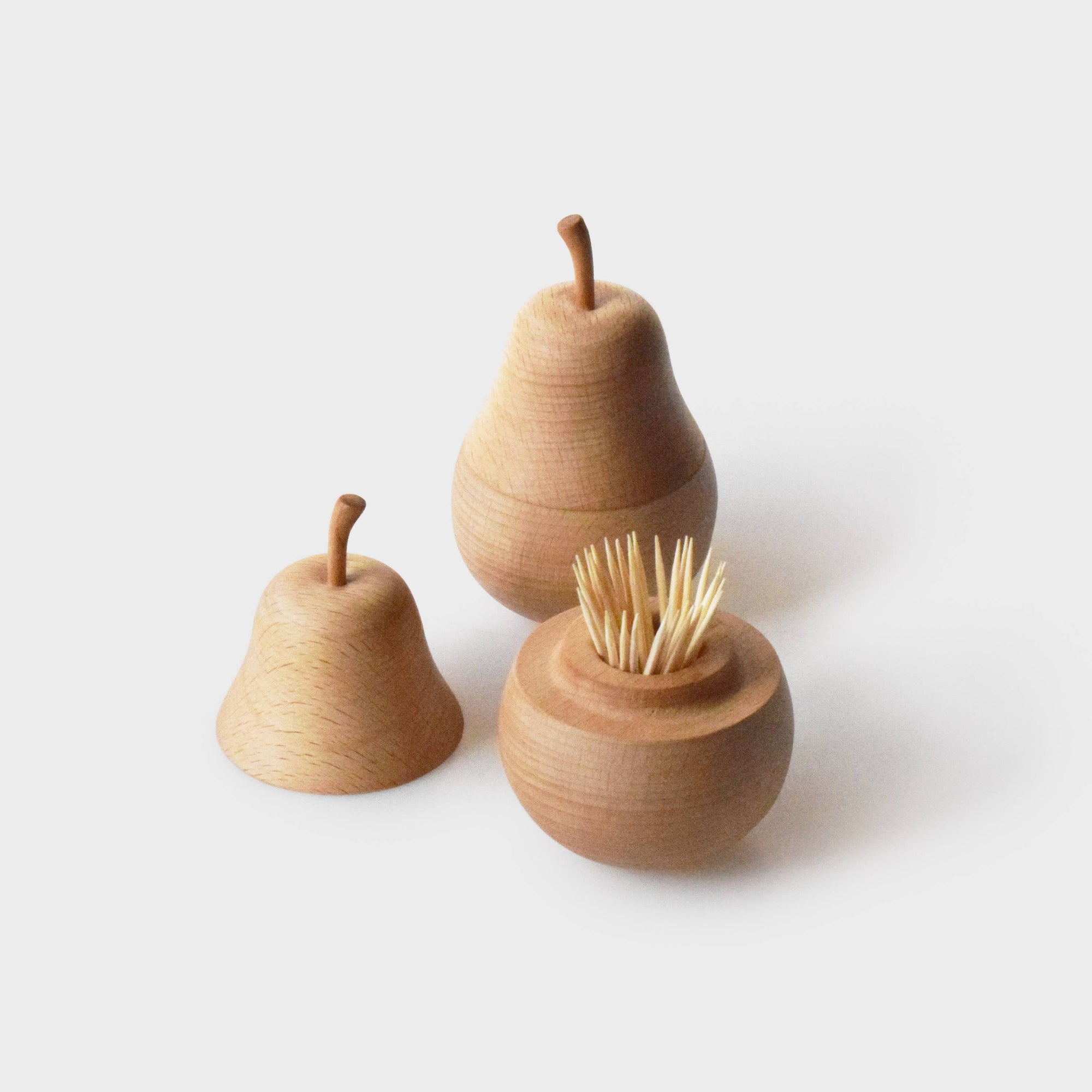 Wooden pear-shaped toothpick holders on a white background