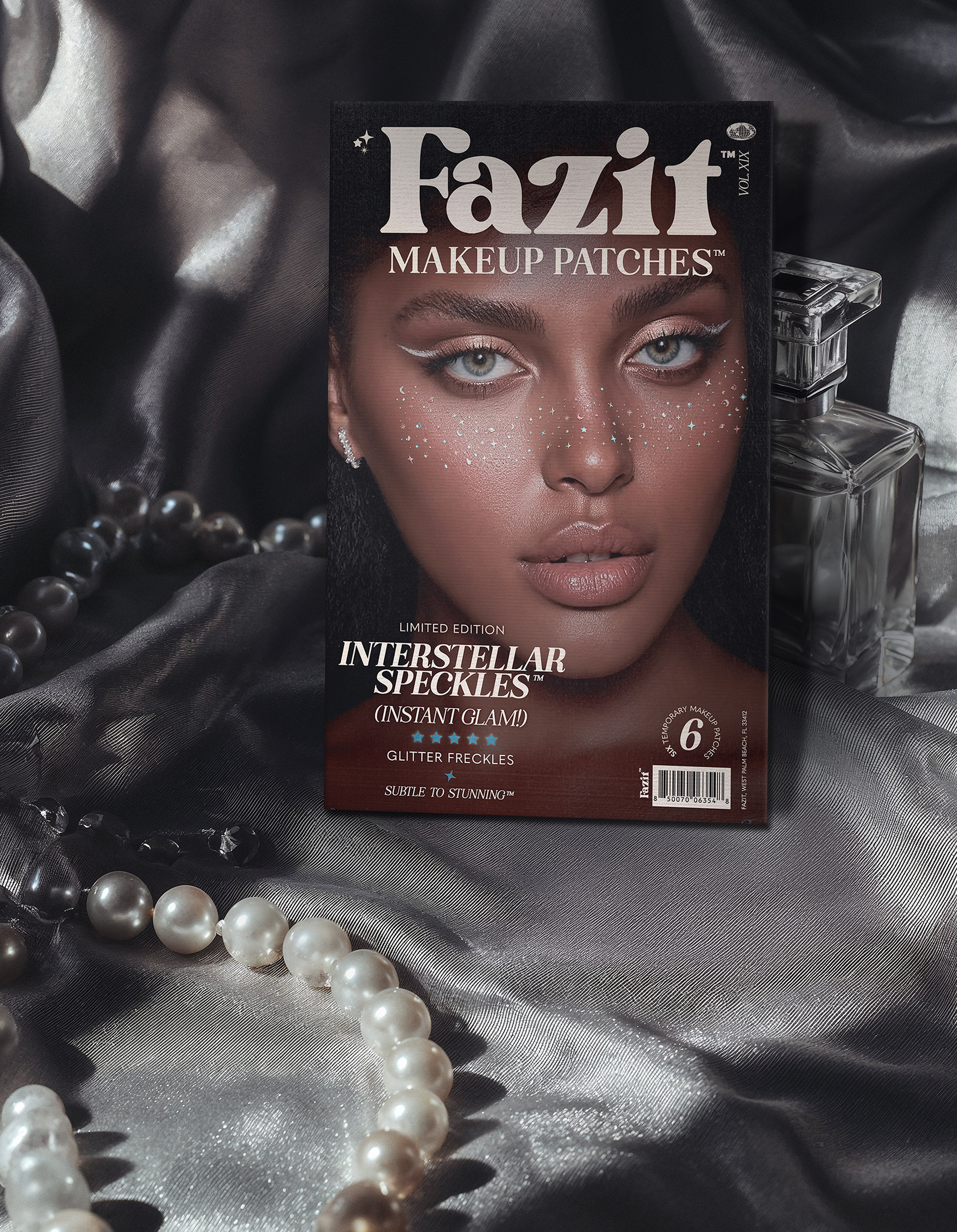 Fazit Makeup Patches packaging on a textured surface with pearls and a perfume bottle.