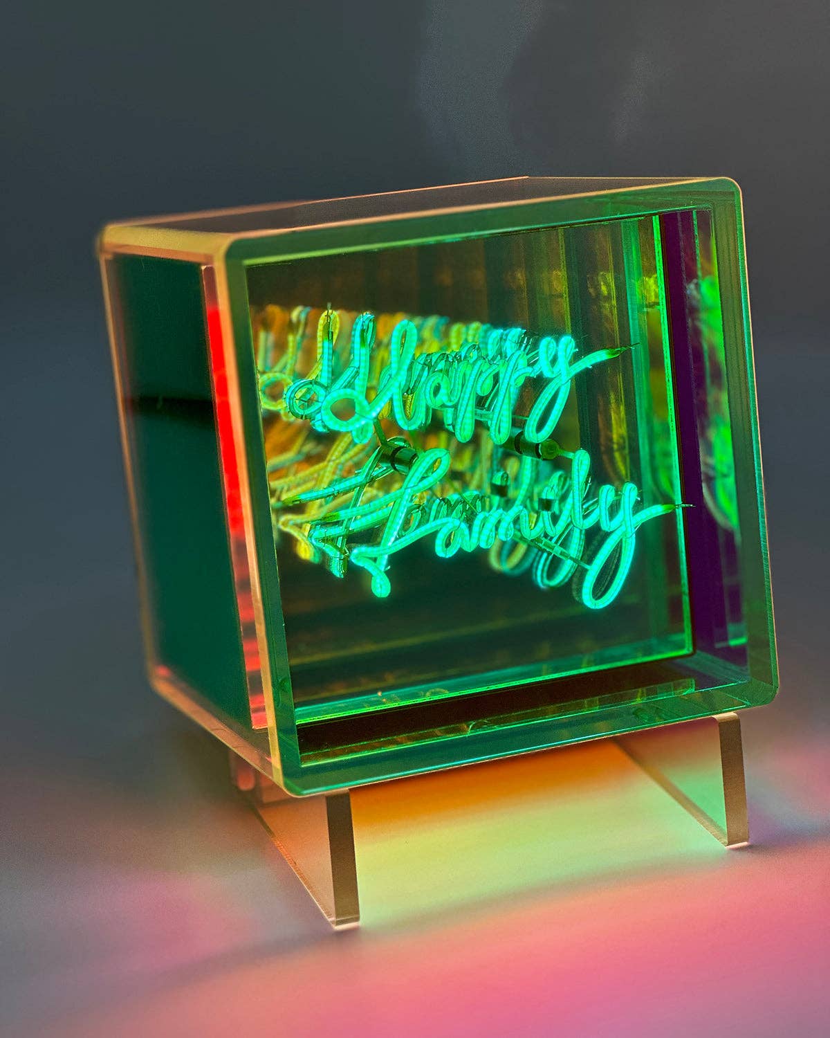 Neon sign with 'Happy family' text in a colorful box on a dark background