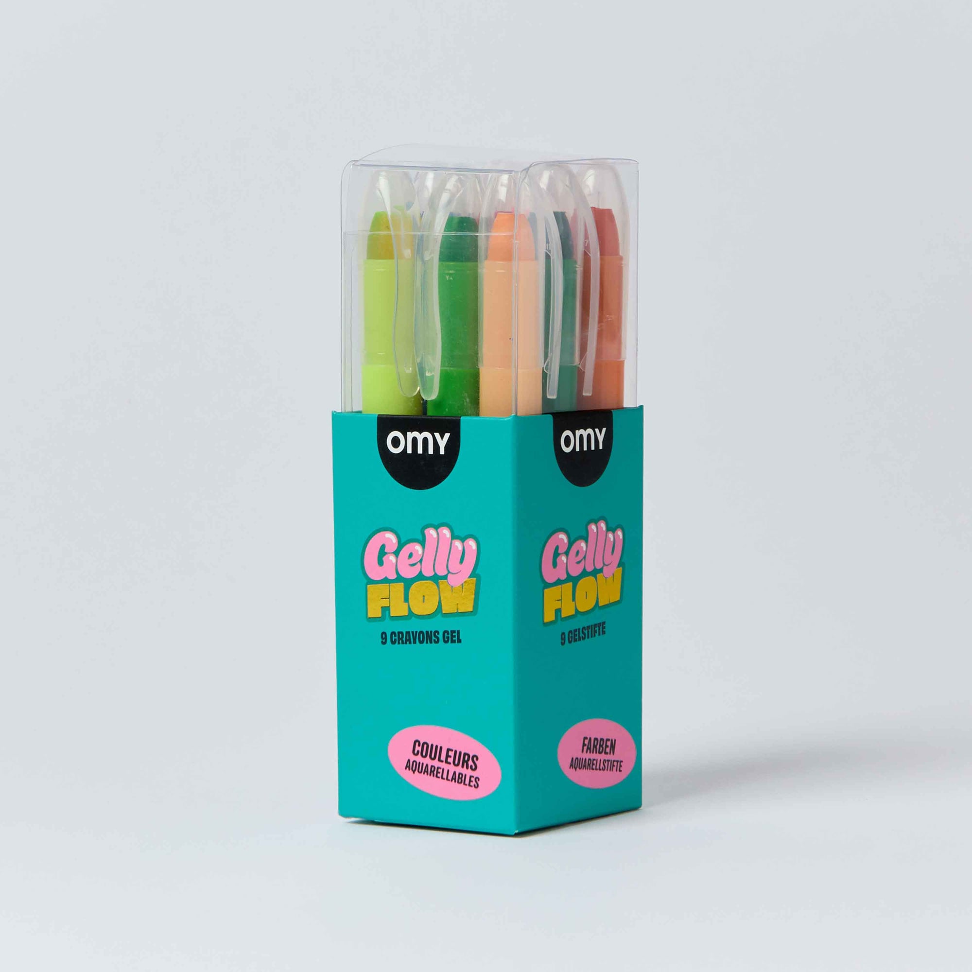 Omy Gelly Flow 8-color gel pens in a teal cardboard display box with a clear plastic top, photographed on a light gray background.