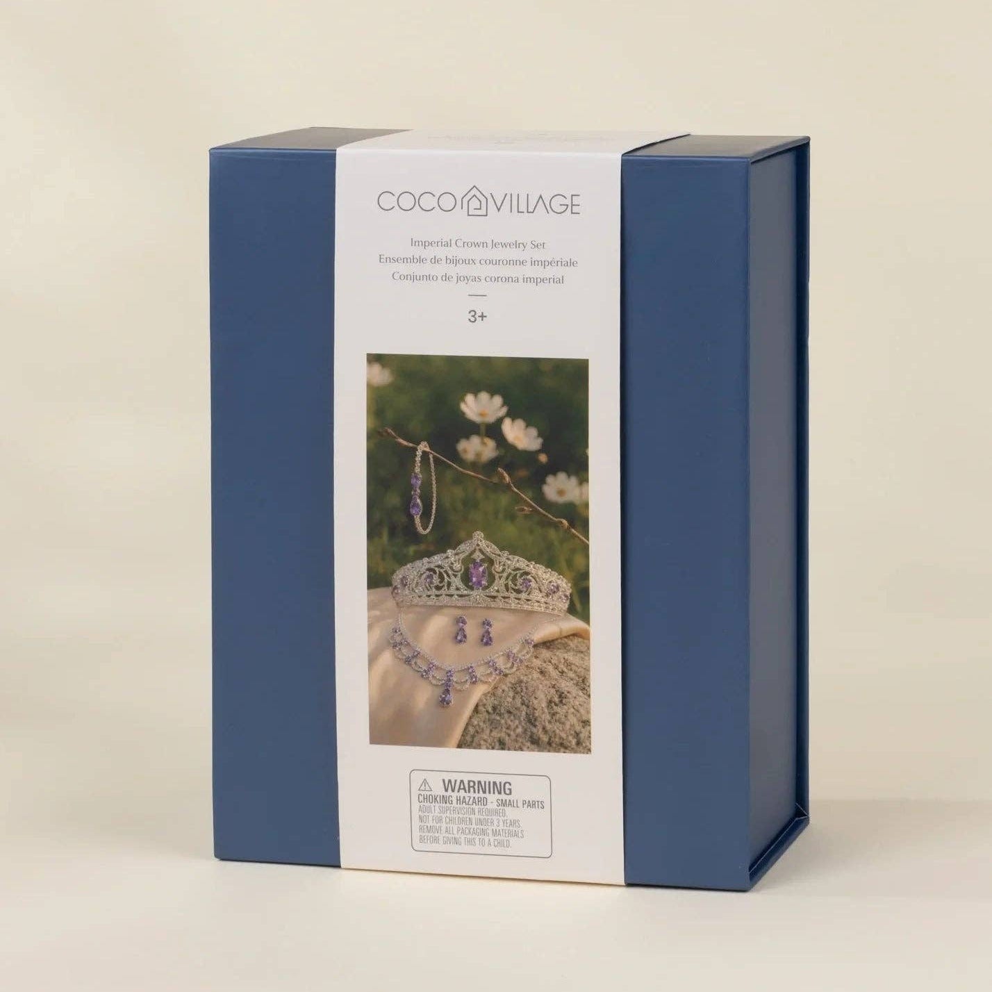 COCO VILLAGE jewelry making kit in a blue and white box, photographed on a warm beige background.