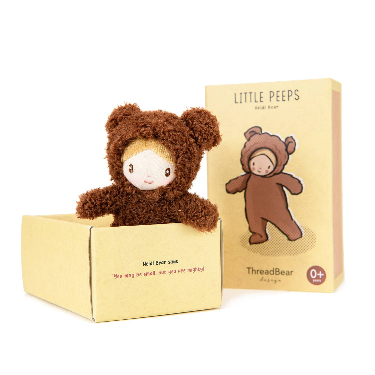 Plush toy in a brown bear costume with packaging on a white background