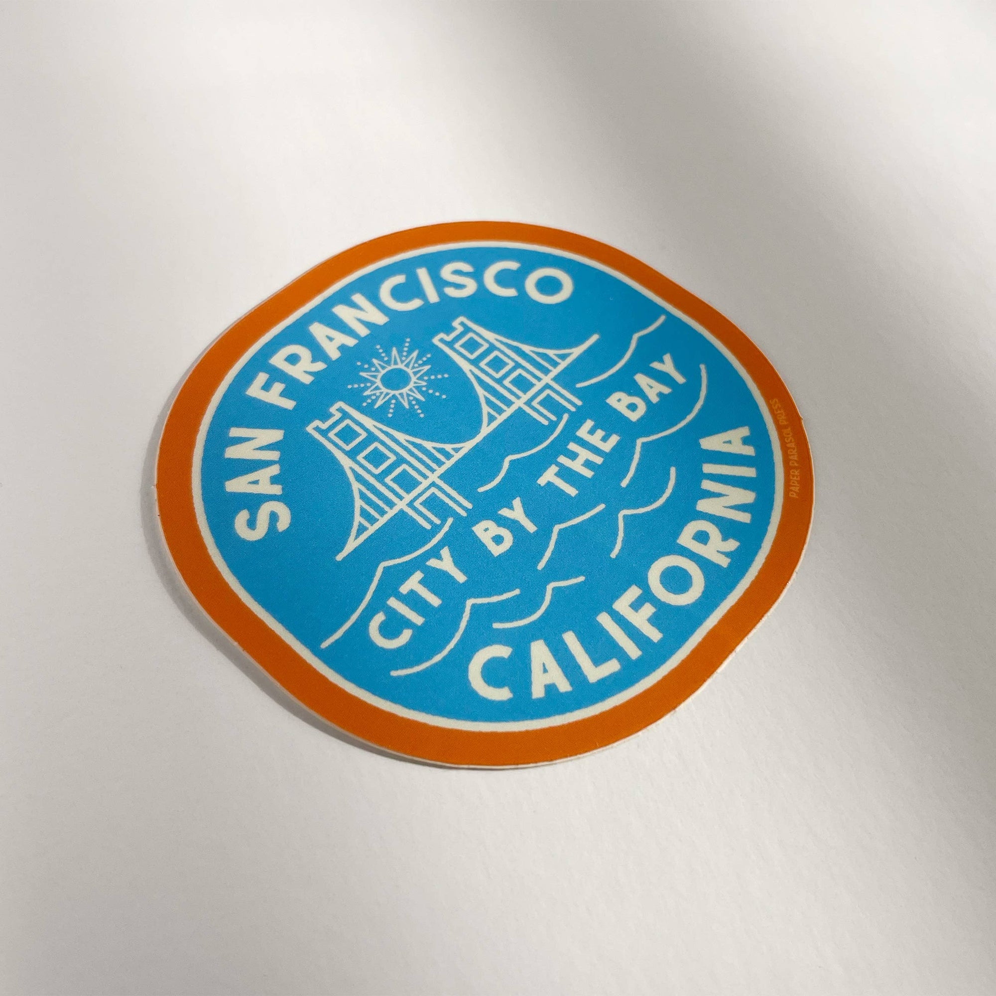 Circular sticker with 'San Francisco, City by the Bay, California' text on a white background