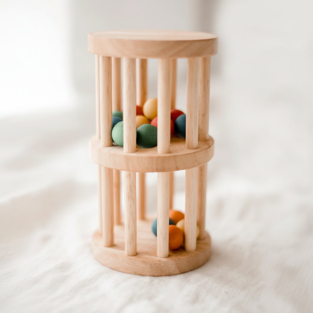Wooden toy with colorful balls inside on a white background