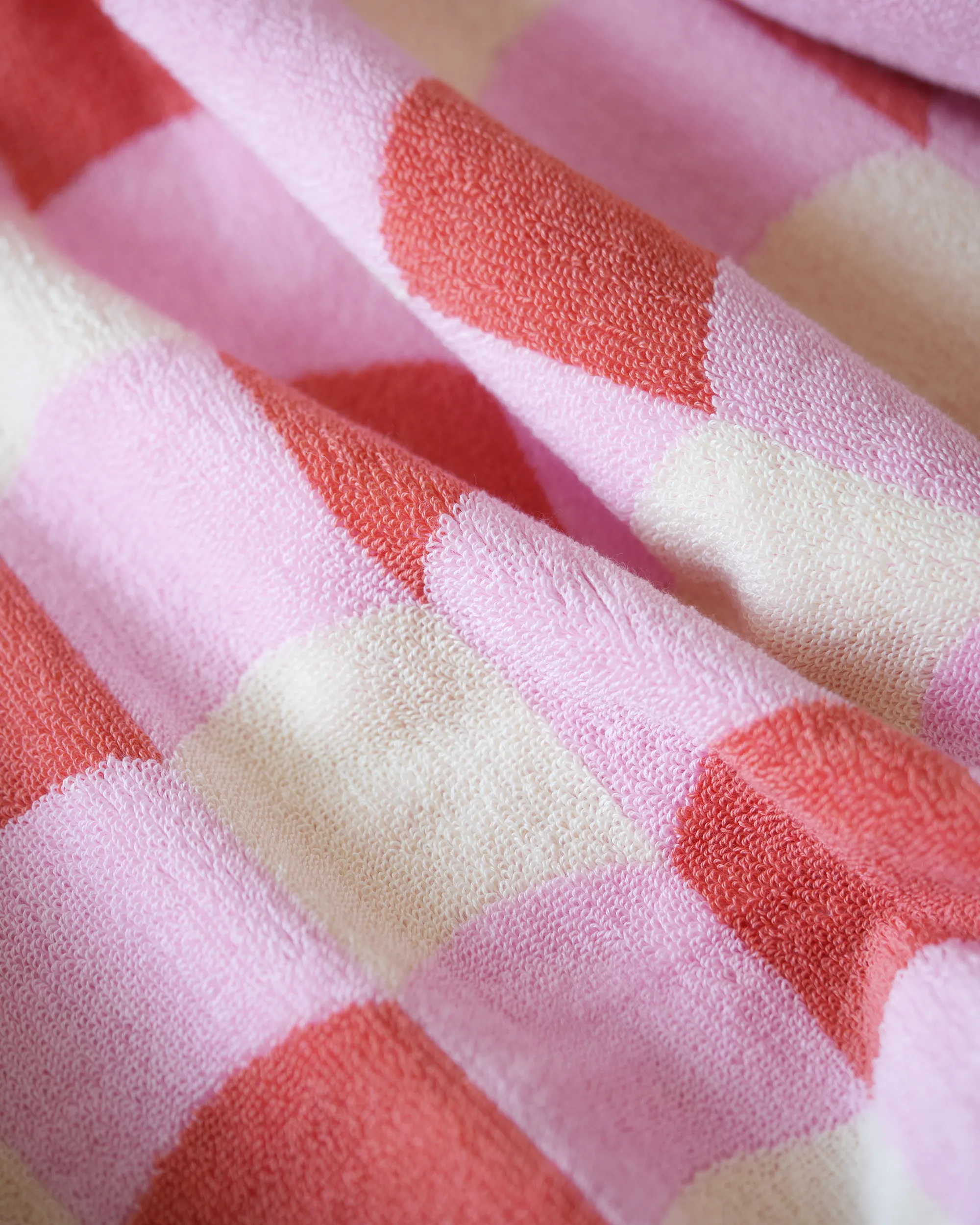 Close-up of a pink and red checkered fabric texture