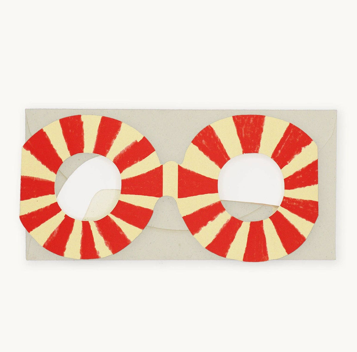 Red and yellow circular sunglasses on a beige background