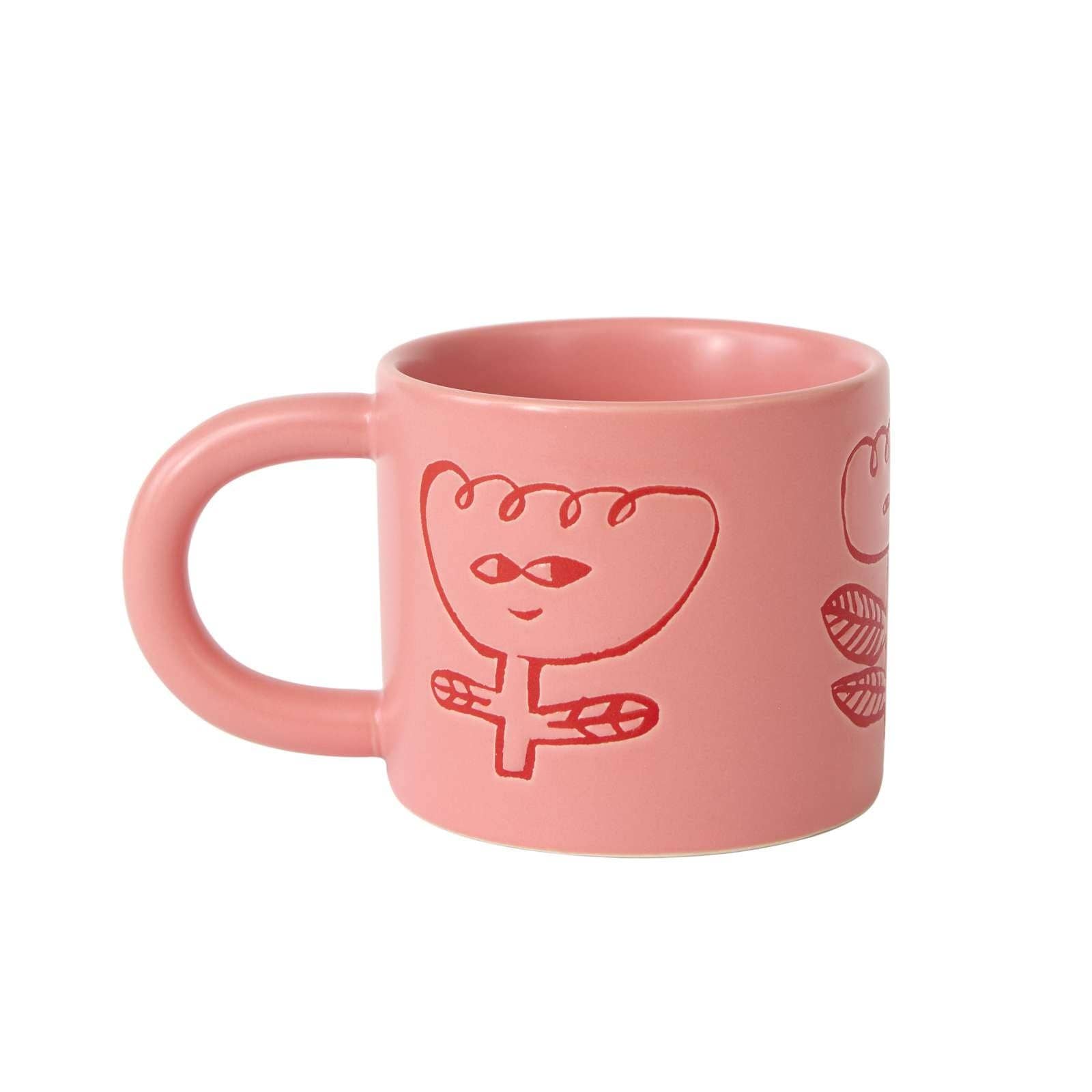 Pink mug with a cartoon character design on a white background
