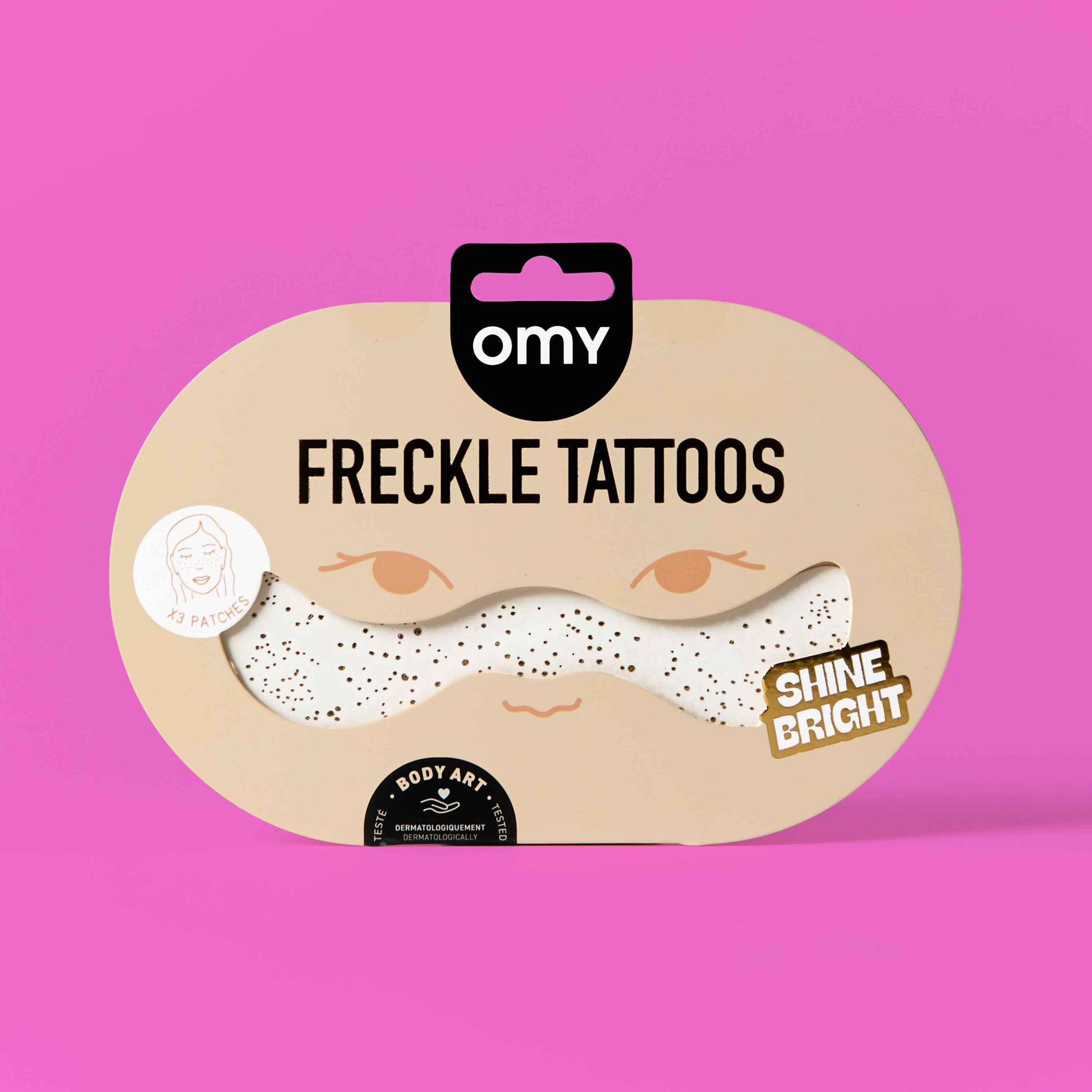 Packaging of freckle tattoos with 'omny' branding on a pink background