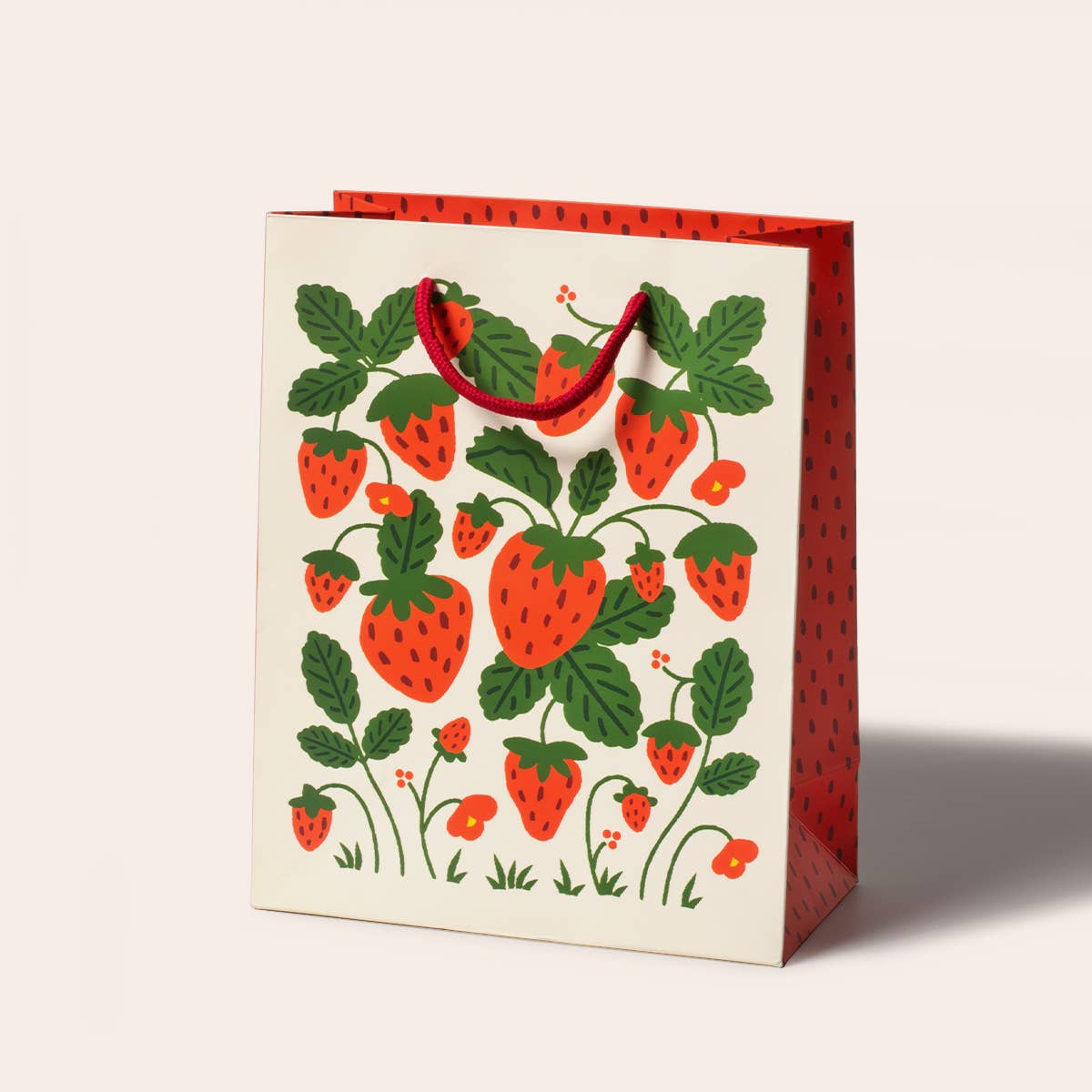 Gift bag with strawberry design on a white background