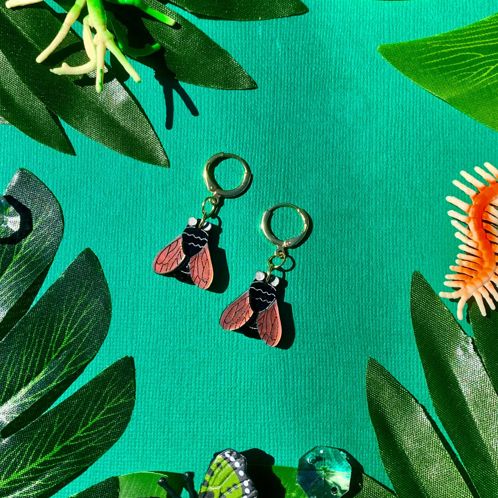 Jewelry set with earrings and pendants on a green leafy background