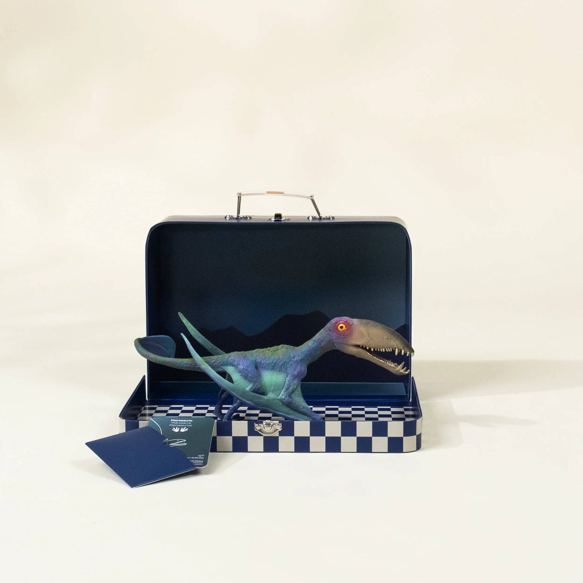 Toy dinosaur inside an open briefcase on a white background