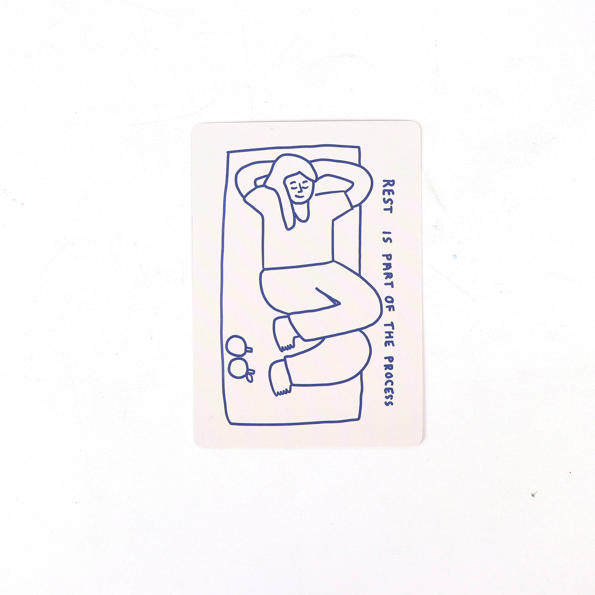 Illustration of a person lying down with 'Rest is part of the process' text on a white background