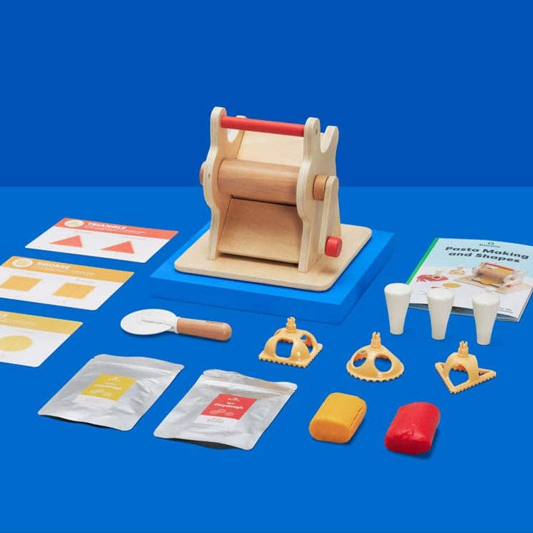 Wooden toy kitchen set with various components on a blue background