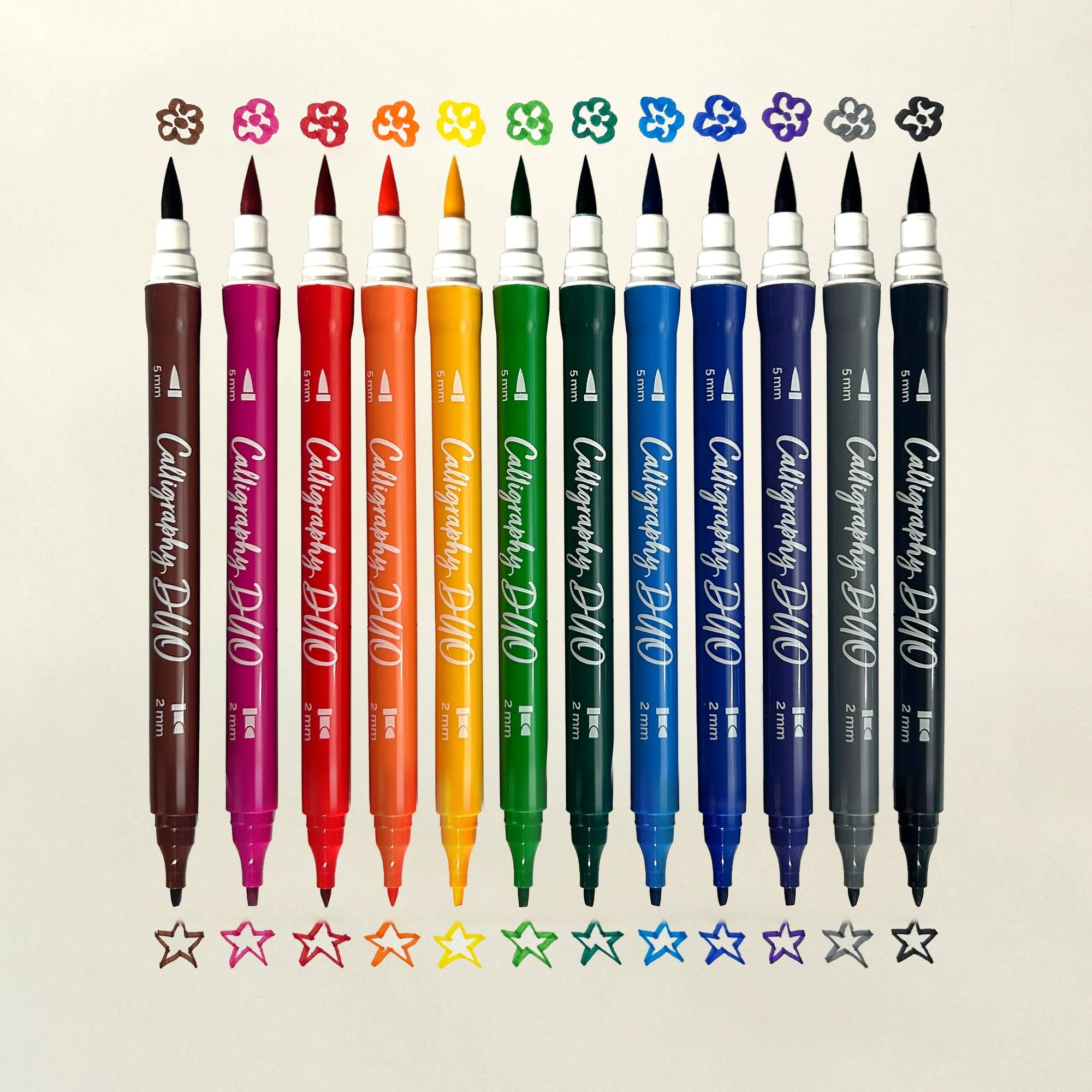 Set of Caligraphy DUO markers in various colors on a beige background