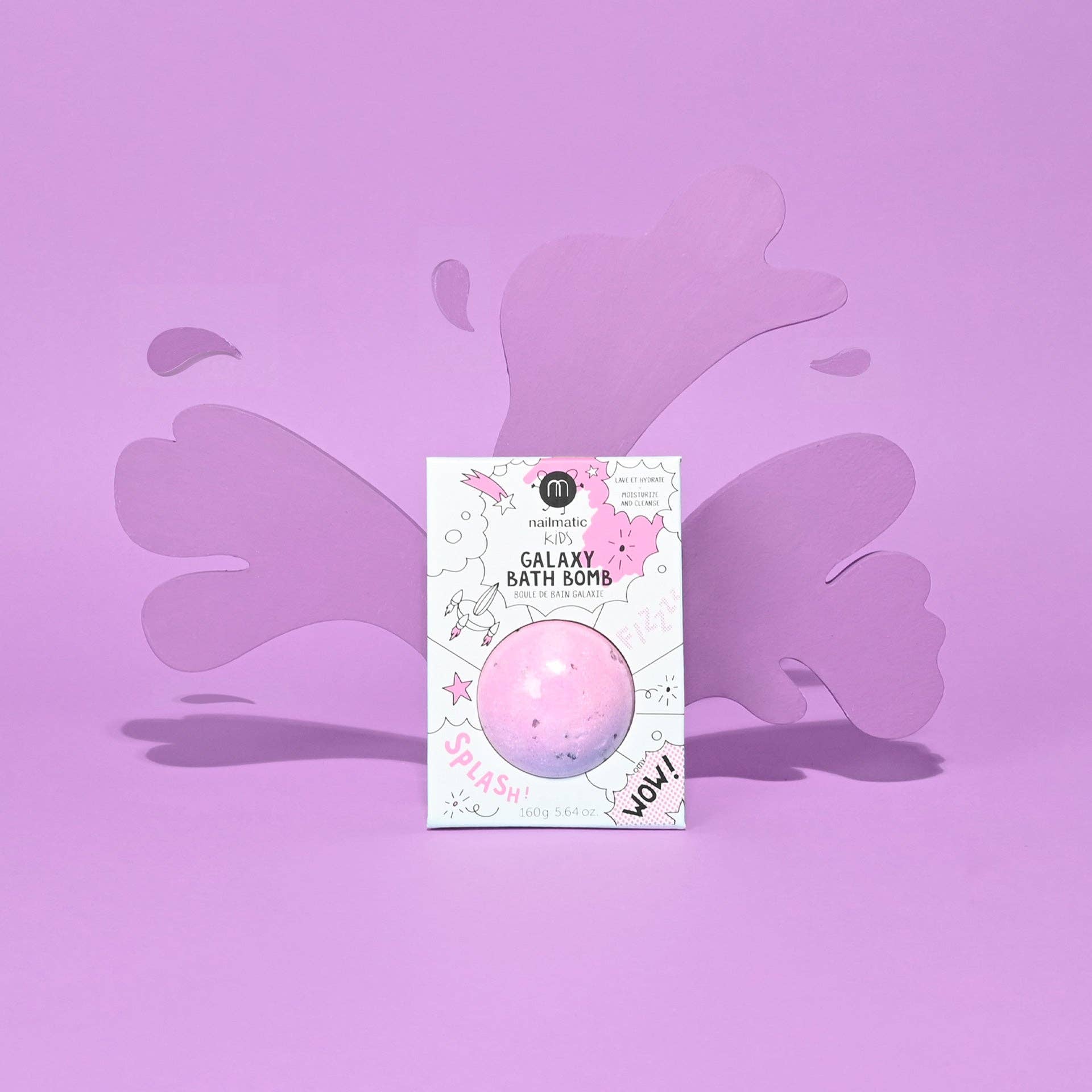 Pink galaxy bath bomb in packaging on a purple background