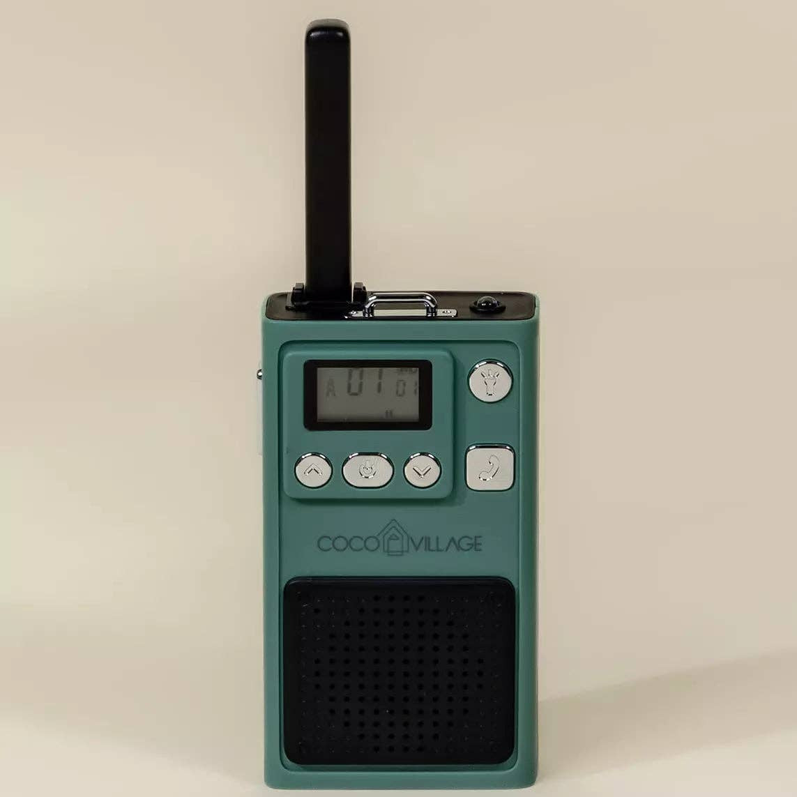 Green radio receiver with 'COCO VILLAGE' branding on a beige background
