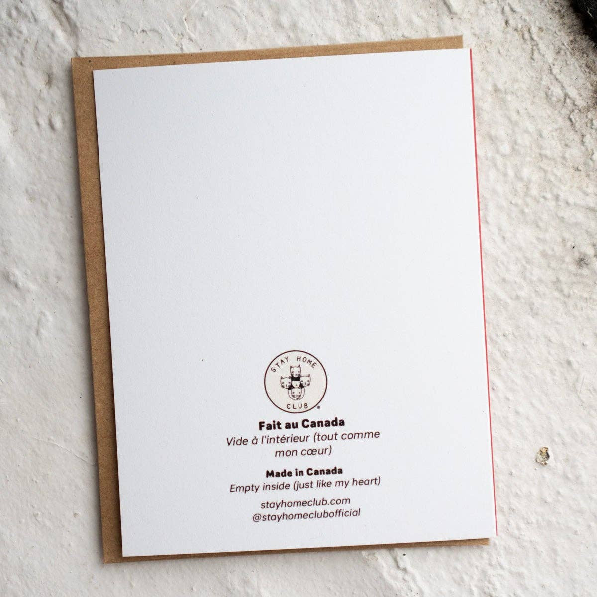 White card with text and logo on a textured white surface