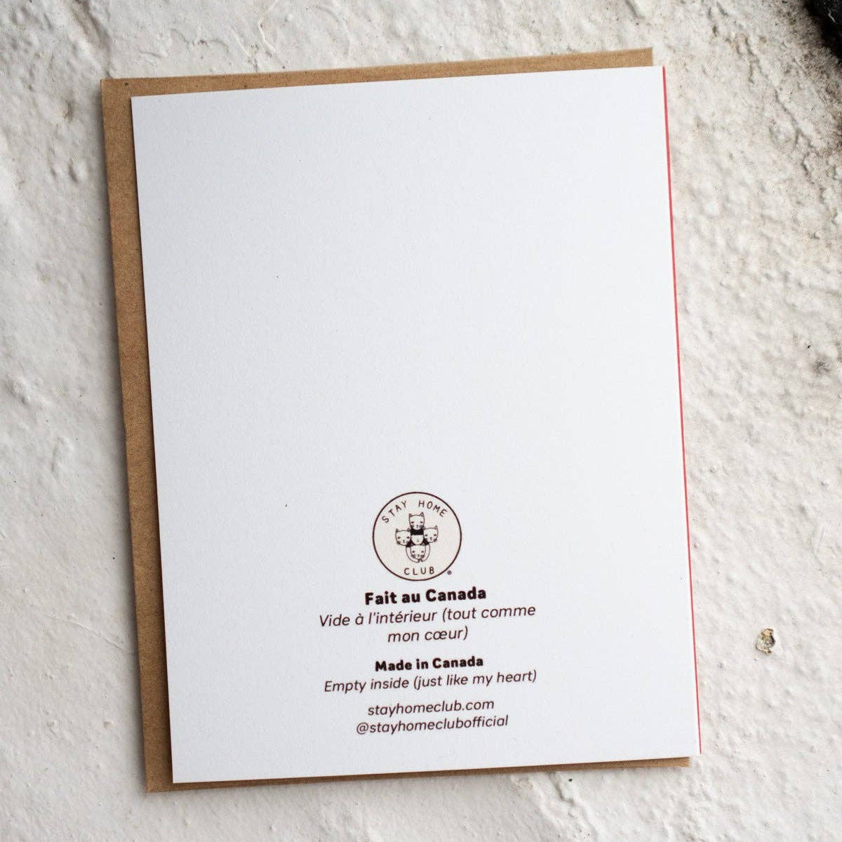 White card with text and logo on a textured white surface