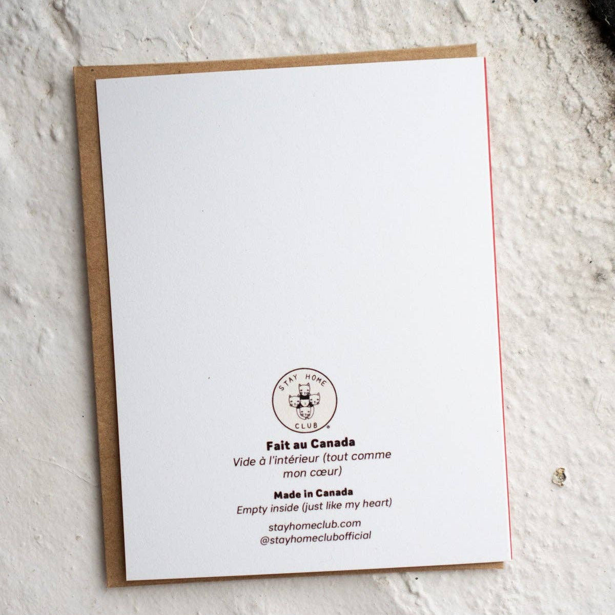 White card with text and logo on a textured white surface