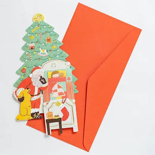 Set of Christmas-themed cutout decorations with a red envelope on a light gray background