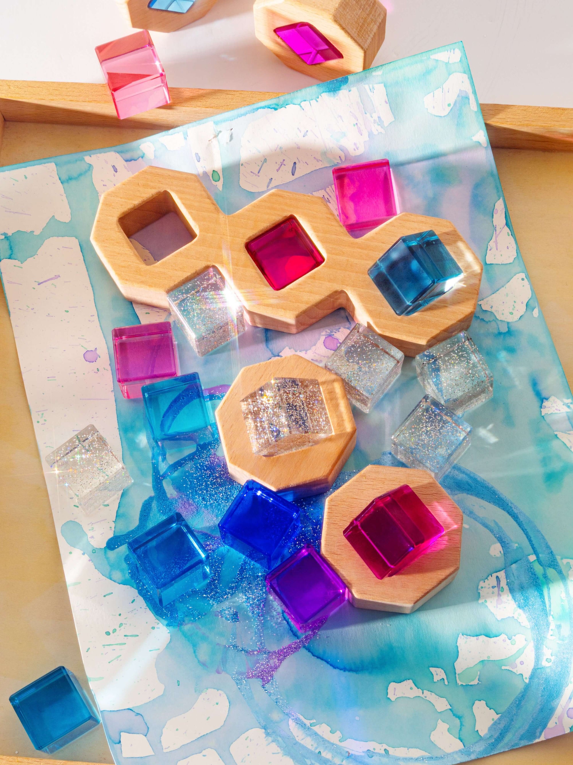 Wooden puzzle with colorful acrylic gems on a decorative mat