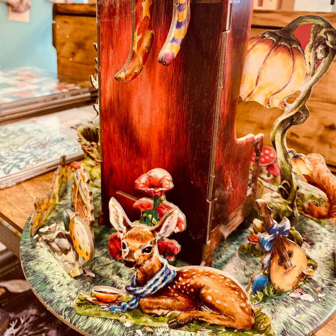Decorative piece with a deer and floral elements on a wooden base