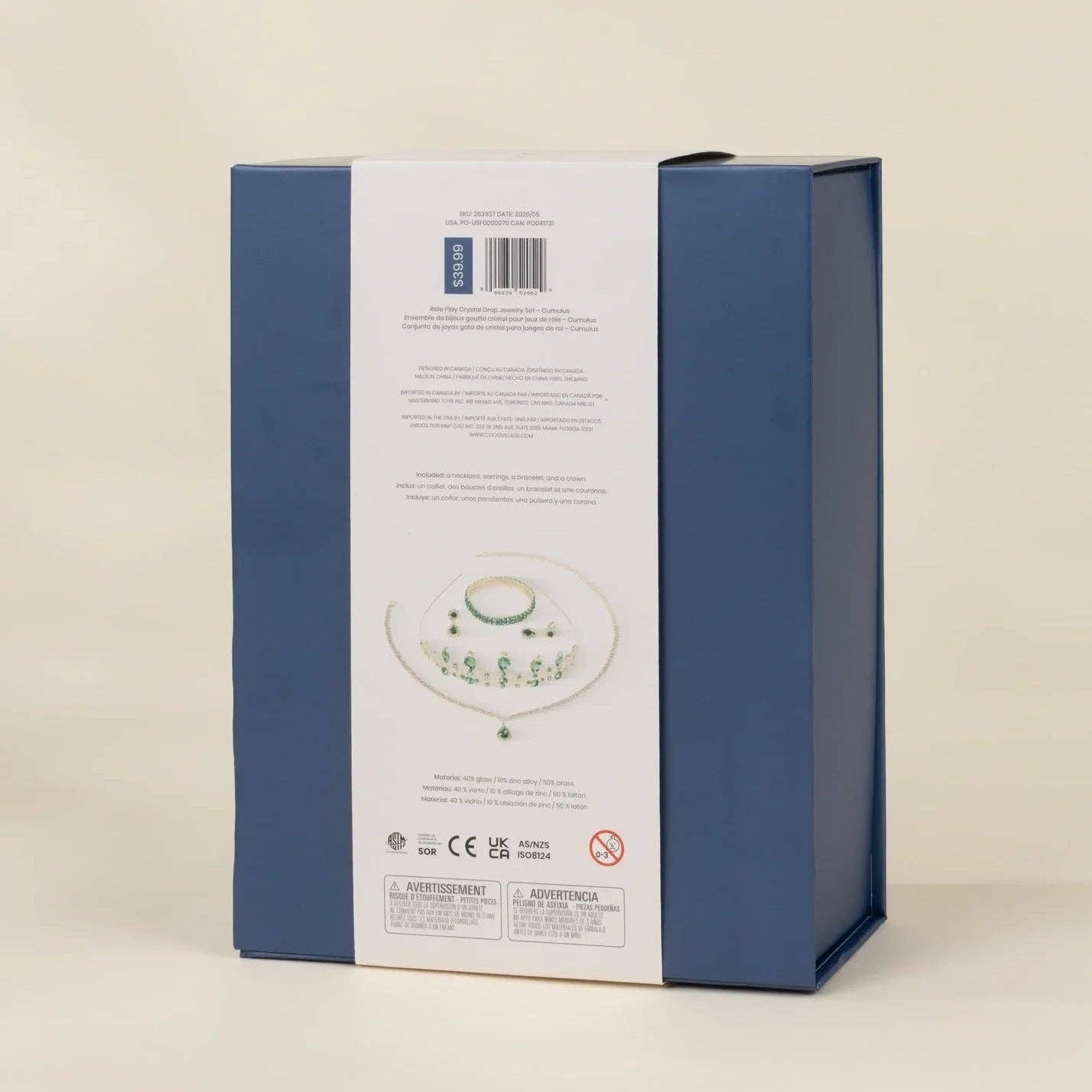 The back of a blue product box with a white label strip, showing a small printed illustration of a white plate with green floral detailing and regulatory text, photographed on a light beige background.