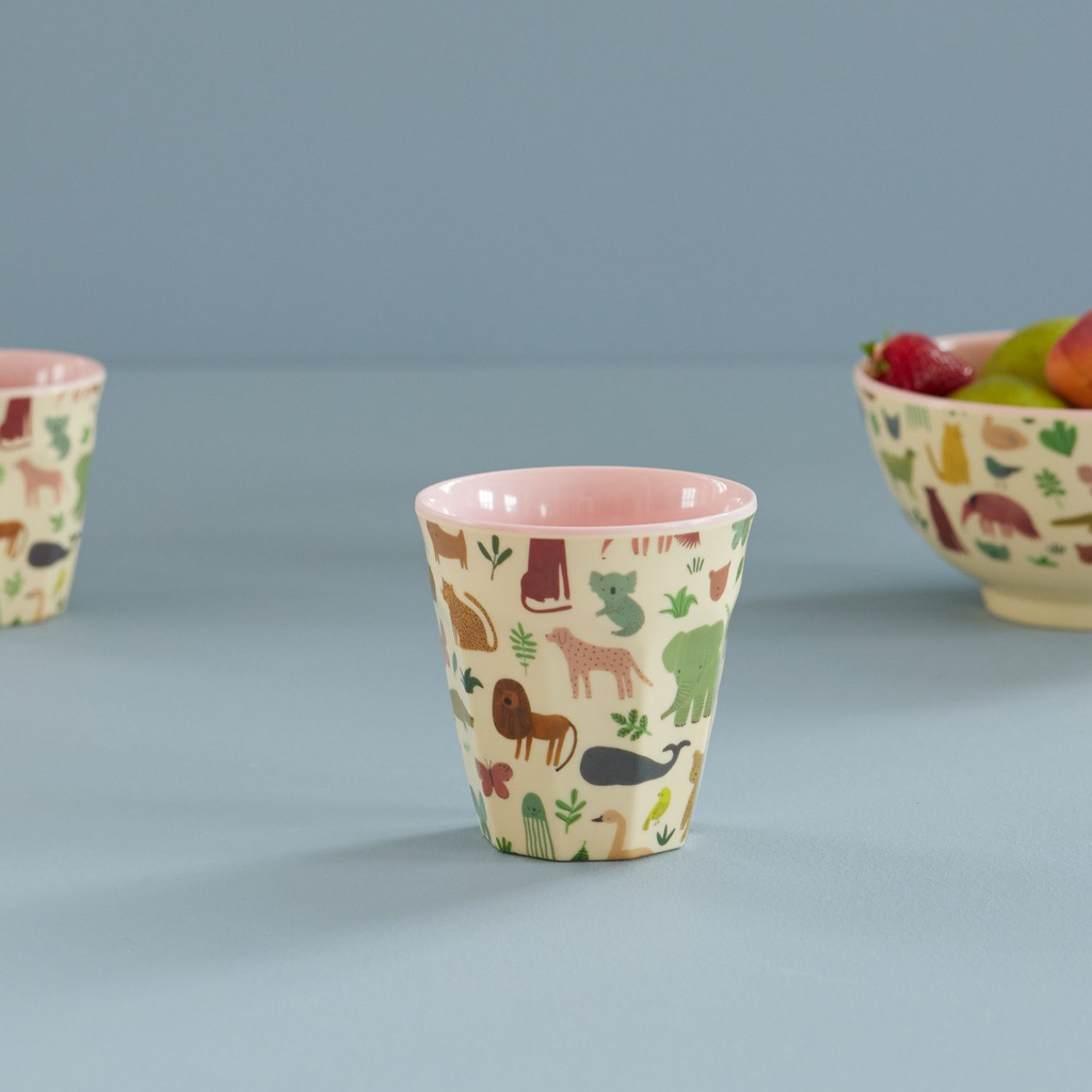 Two children's cups with animal prints on a blue background