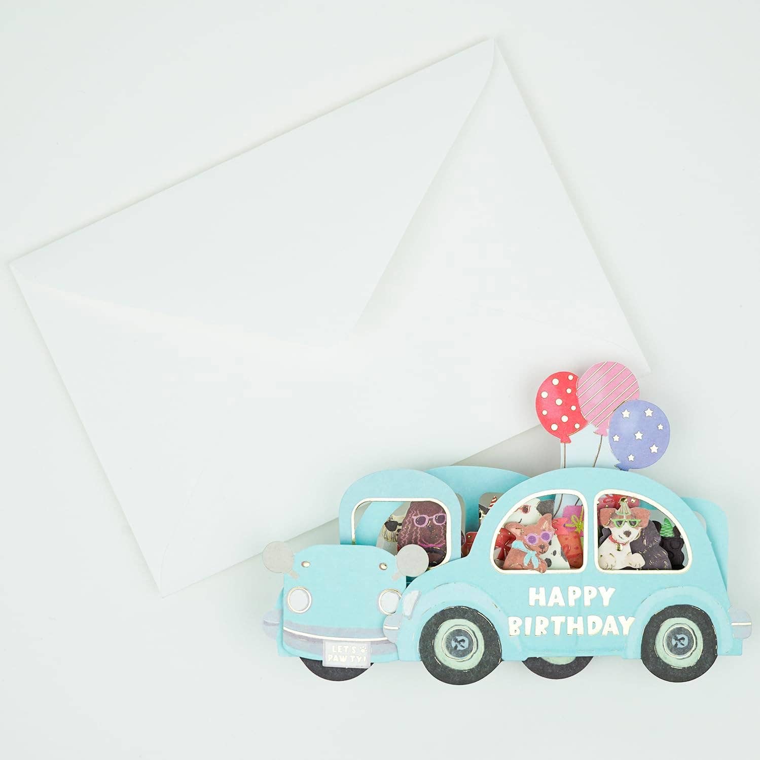 Toy car with teddy bears and balloons on a white background