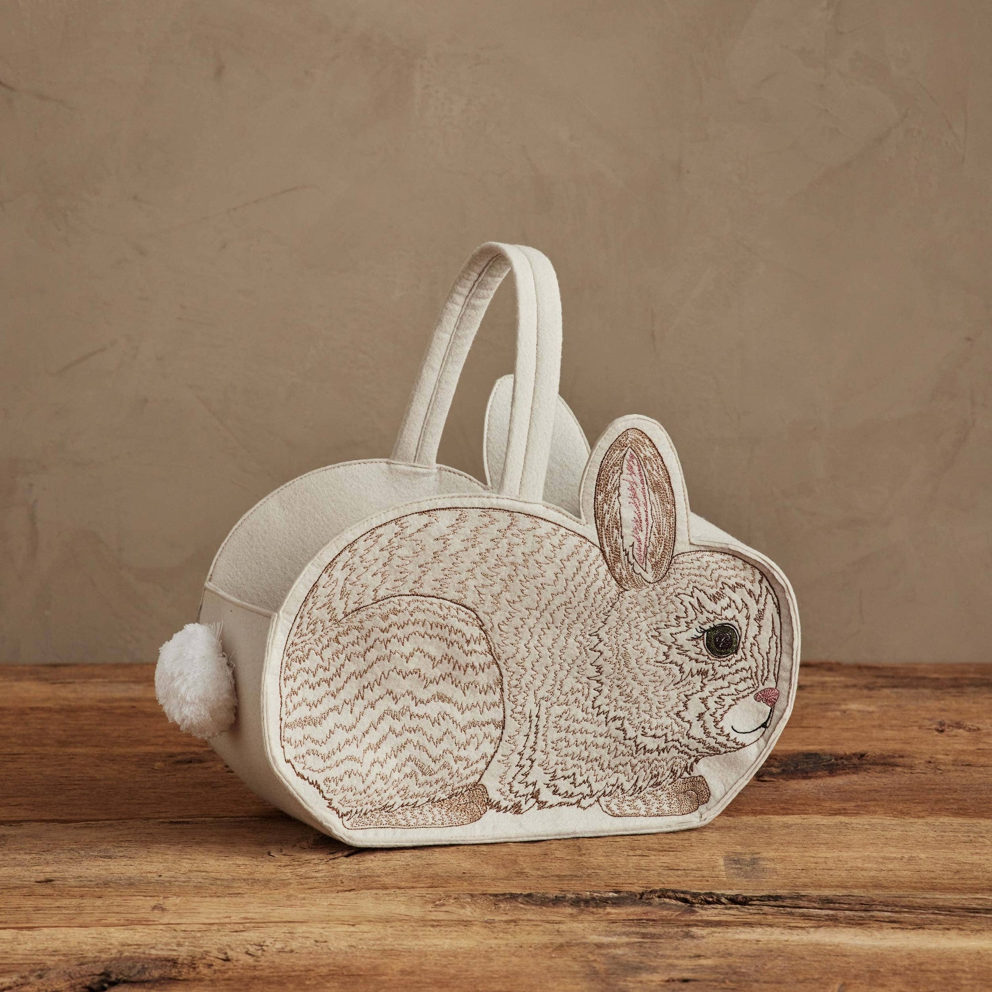 Rabbit-shaped wooden basket on a wooden surface with a brown background