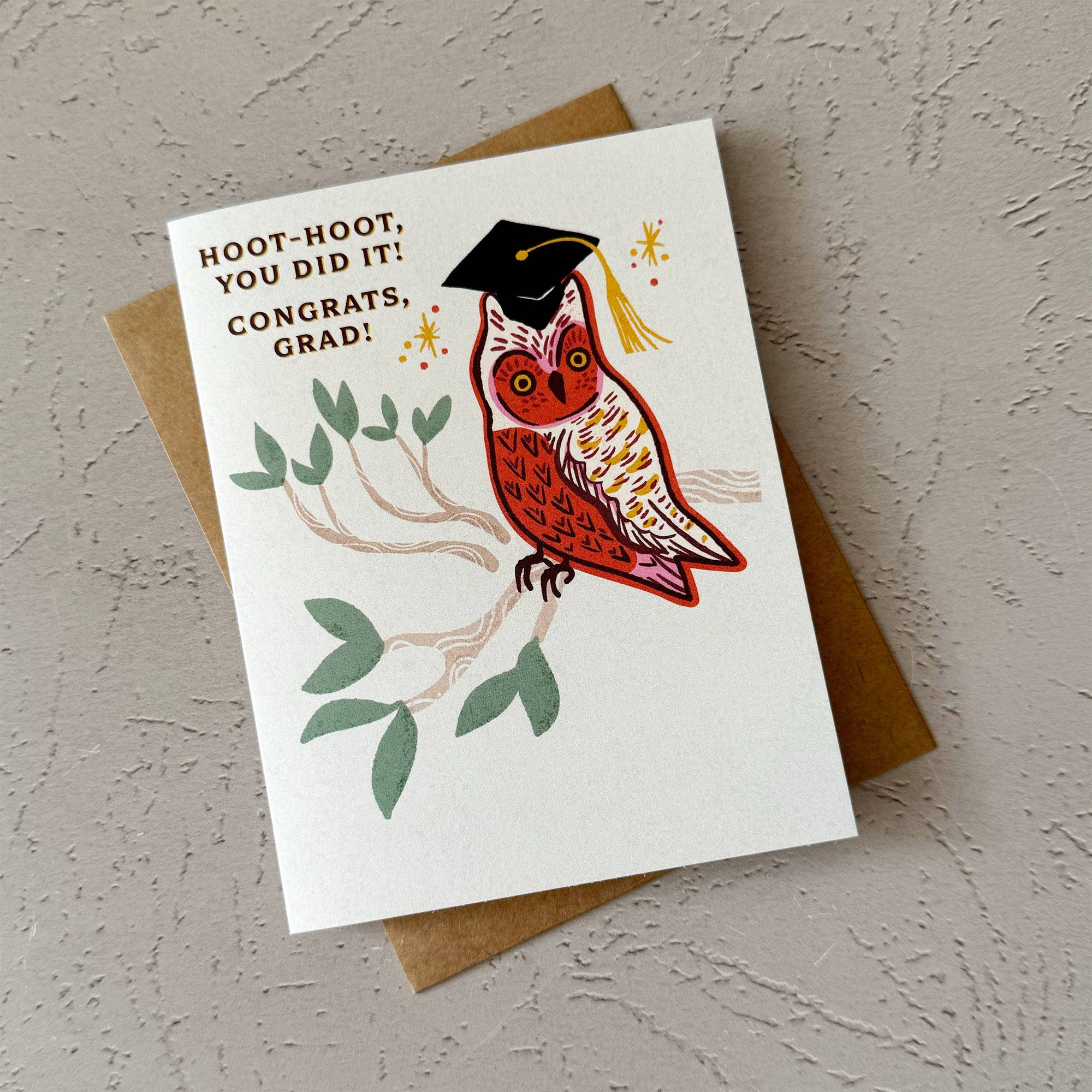 Graduation card with an owl wearing a cap and tassel on a plain background