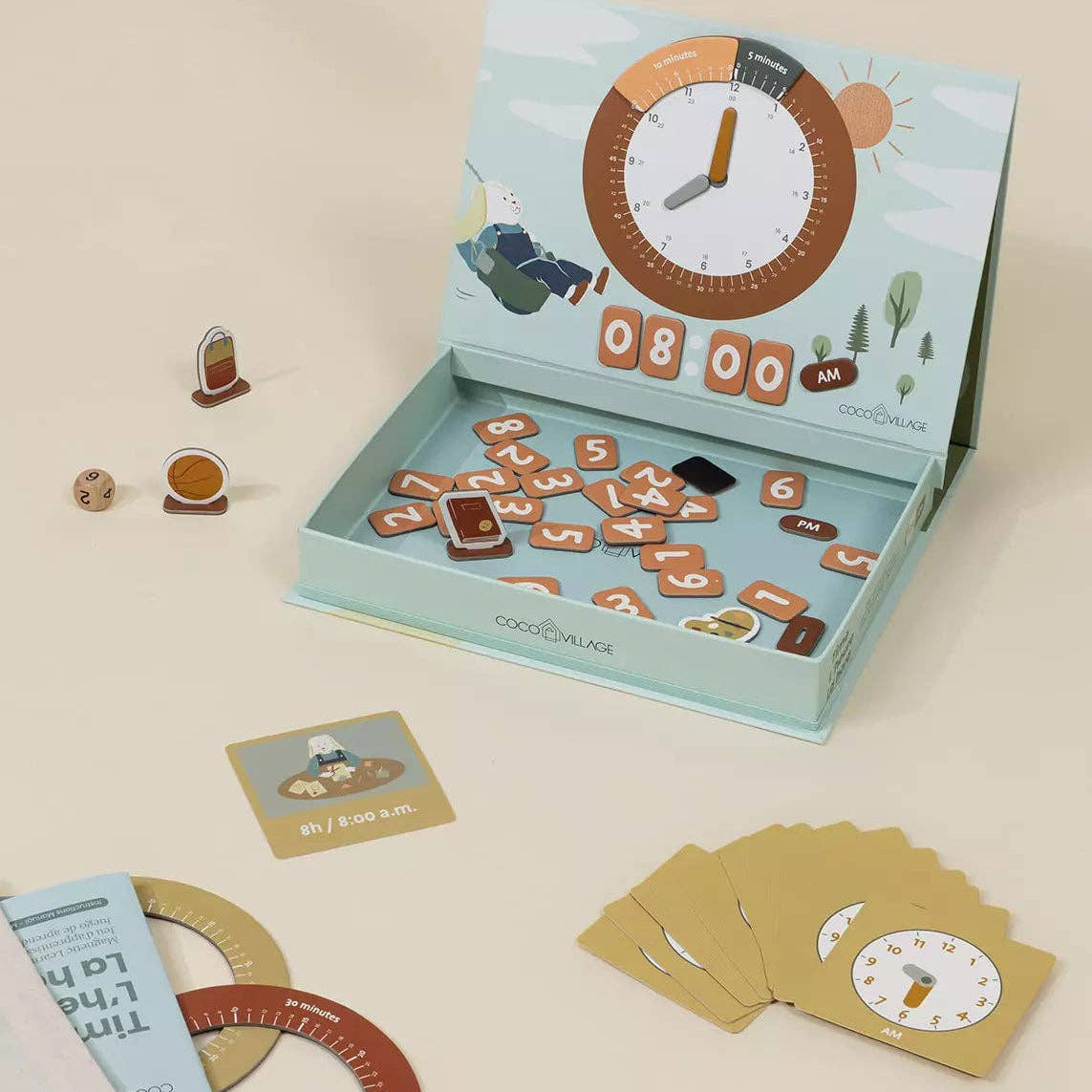 Children's educational clock and number game set with cards and toy clock on a beige background