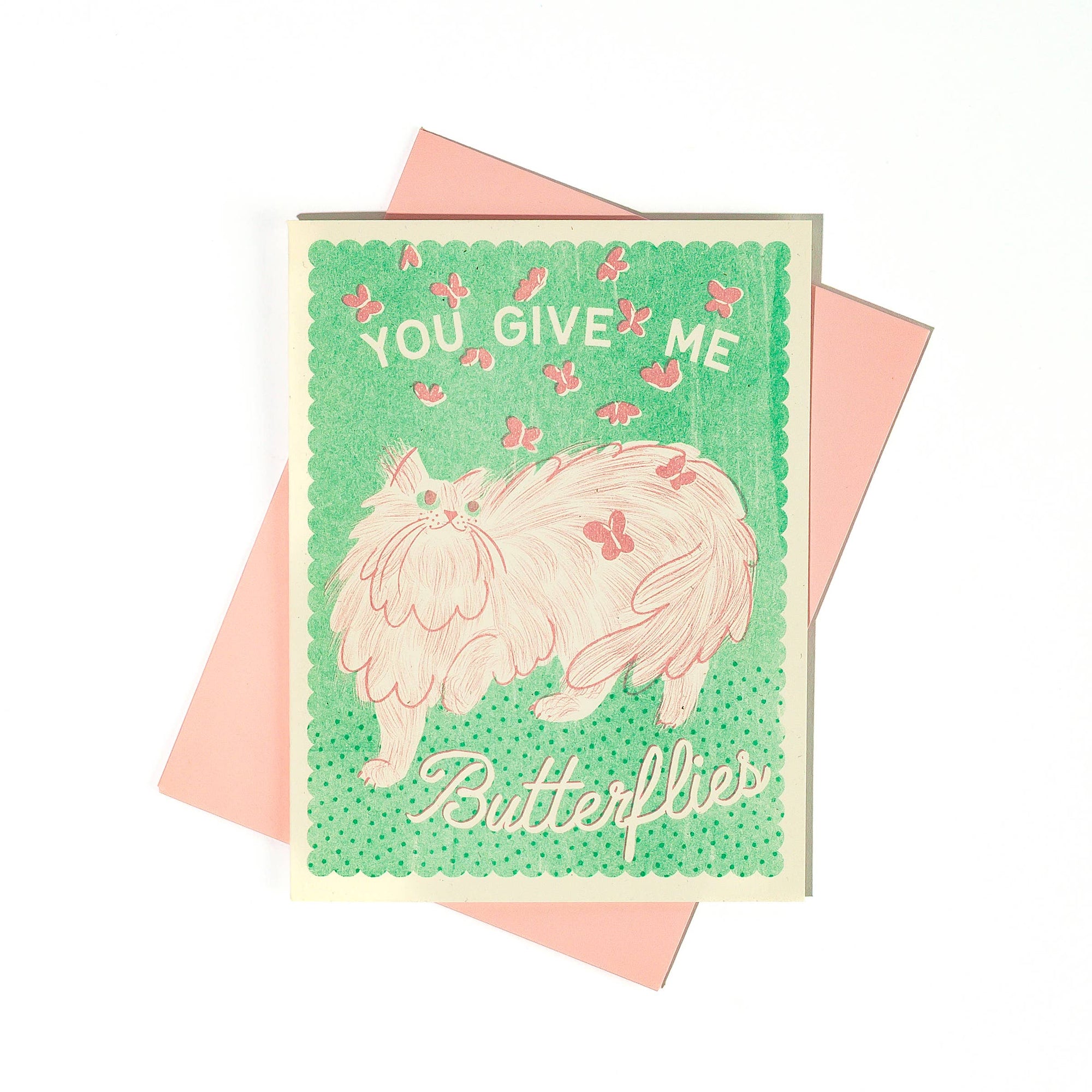 Card with a cat illustration and text 'You give me butterflies' on a green background