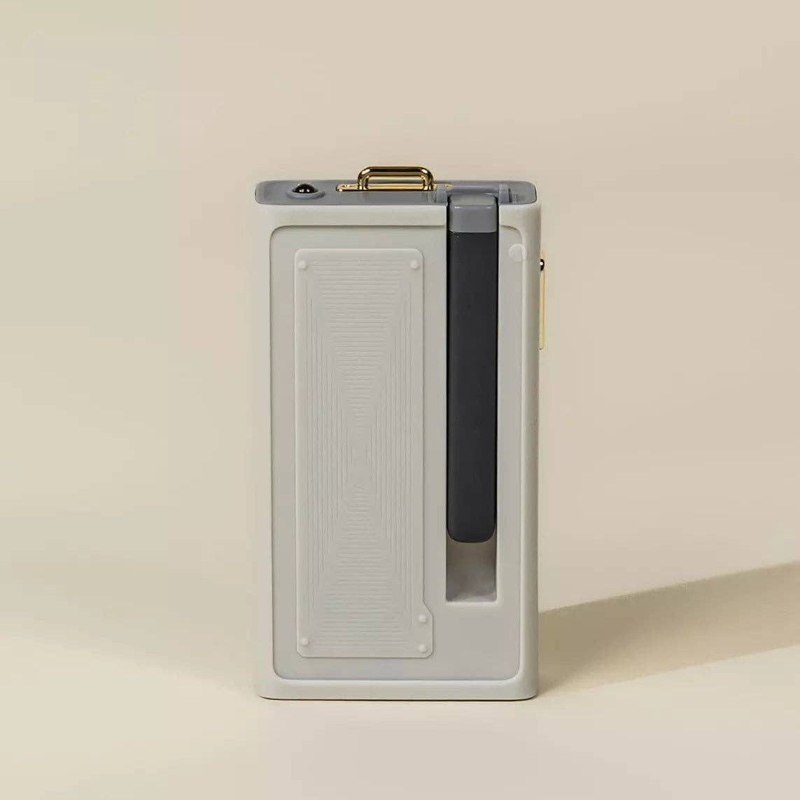 Rectangular electronic device with a metallic finish on a beige background