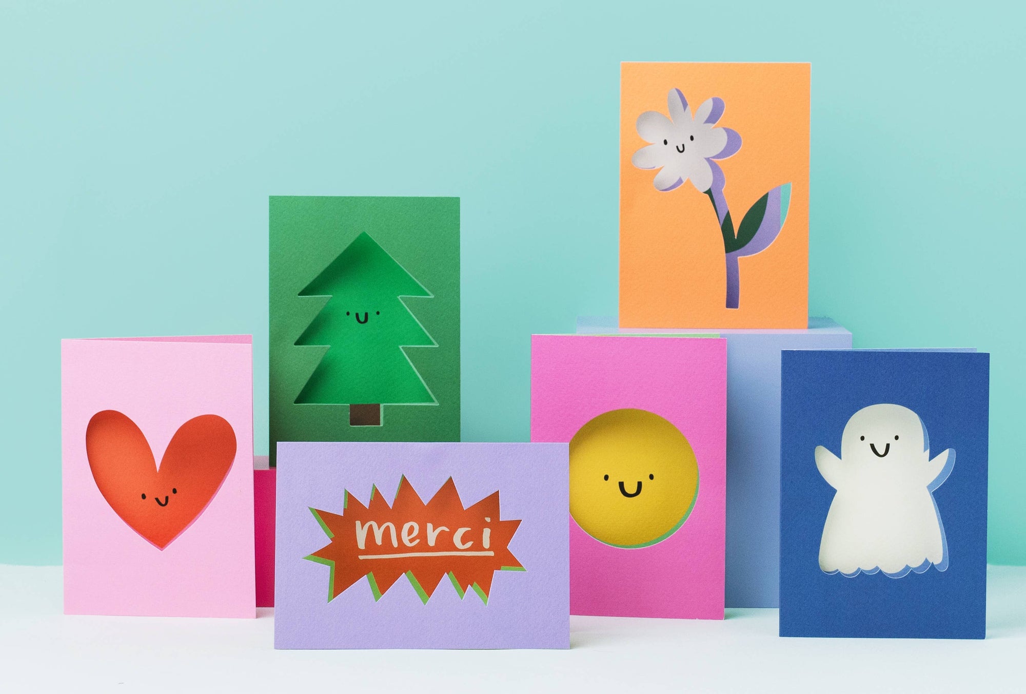 Set of colorful greeting cards with different designs on a light blue background