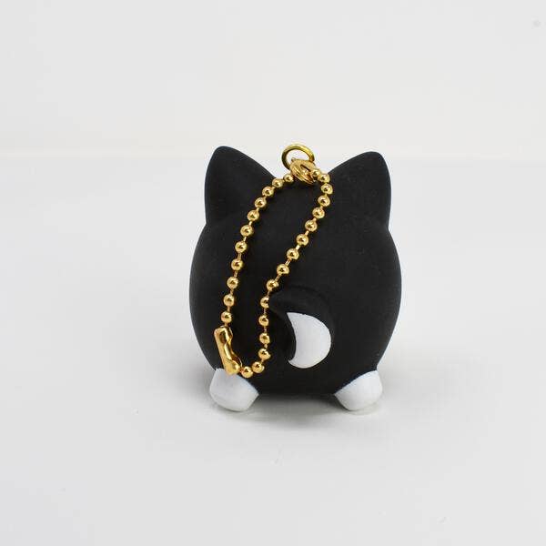 Black cat-shaped keychain with gold chain on a white background