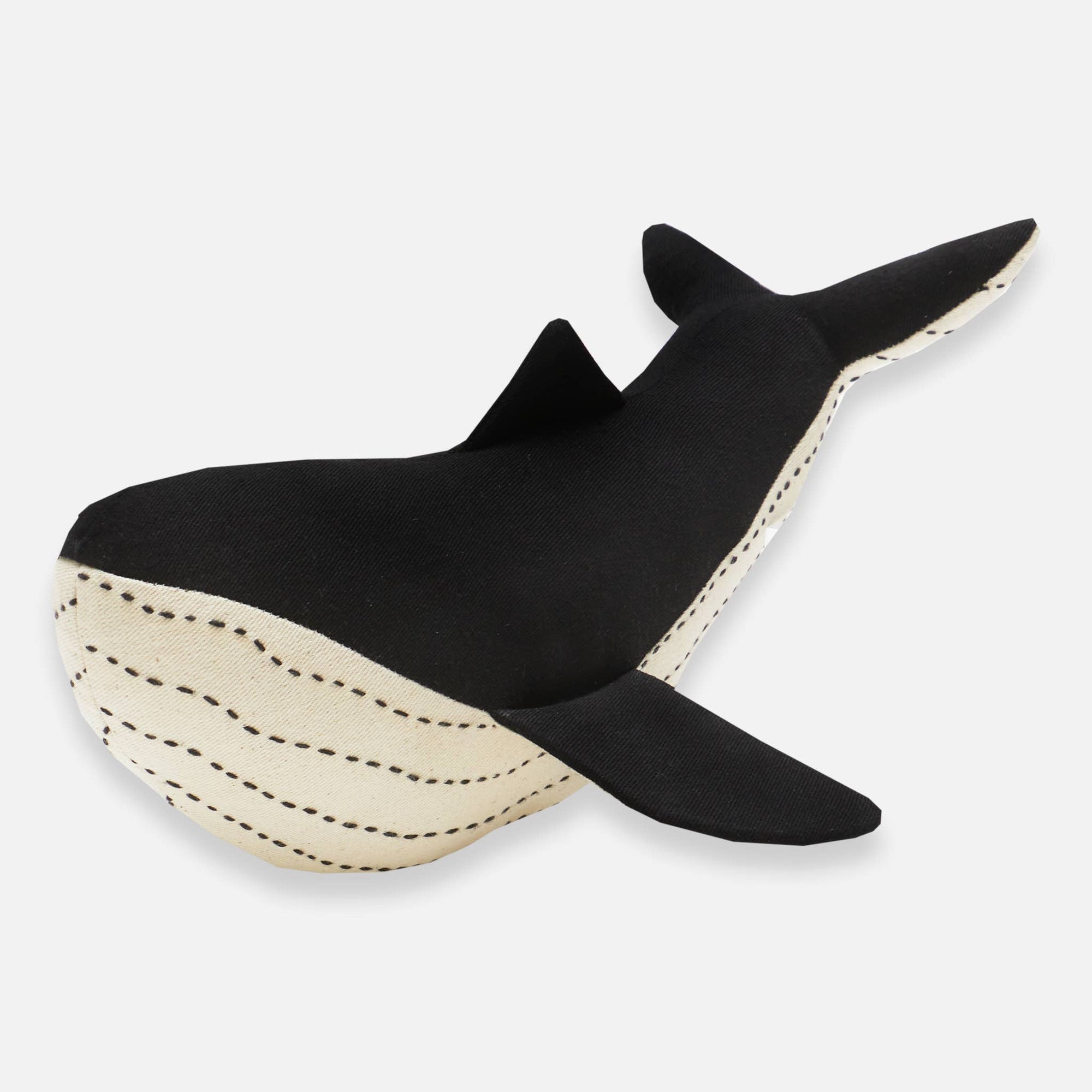Black and beige whale-shaped toy on a white background