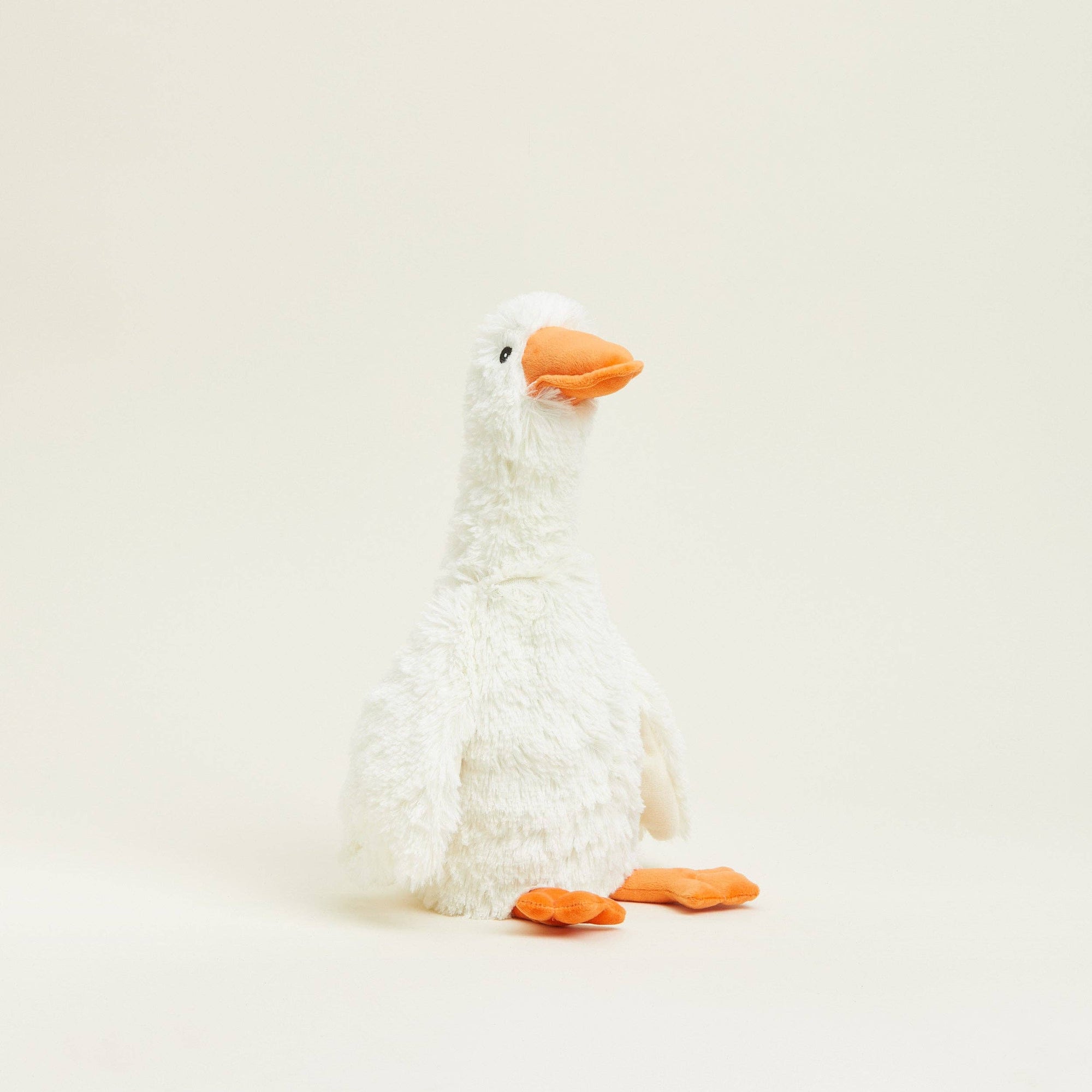 Plush toy goose on a light beige background