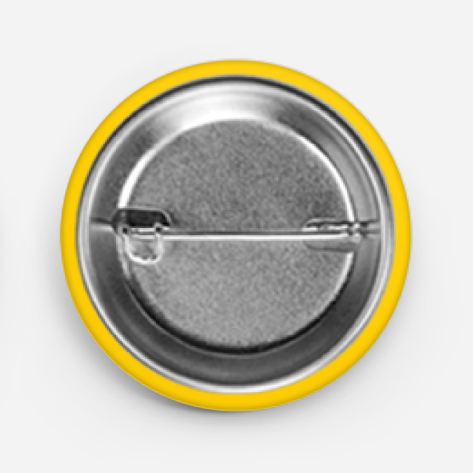 Button badge with yellow rim and metallic center on a light gray background