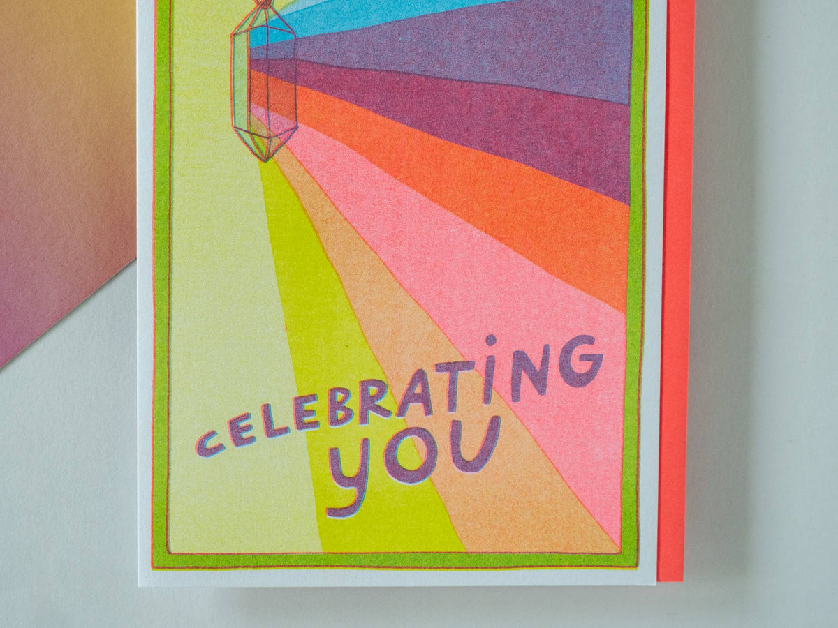 Colorful card with 'Celebrating You' text on a plain background