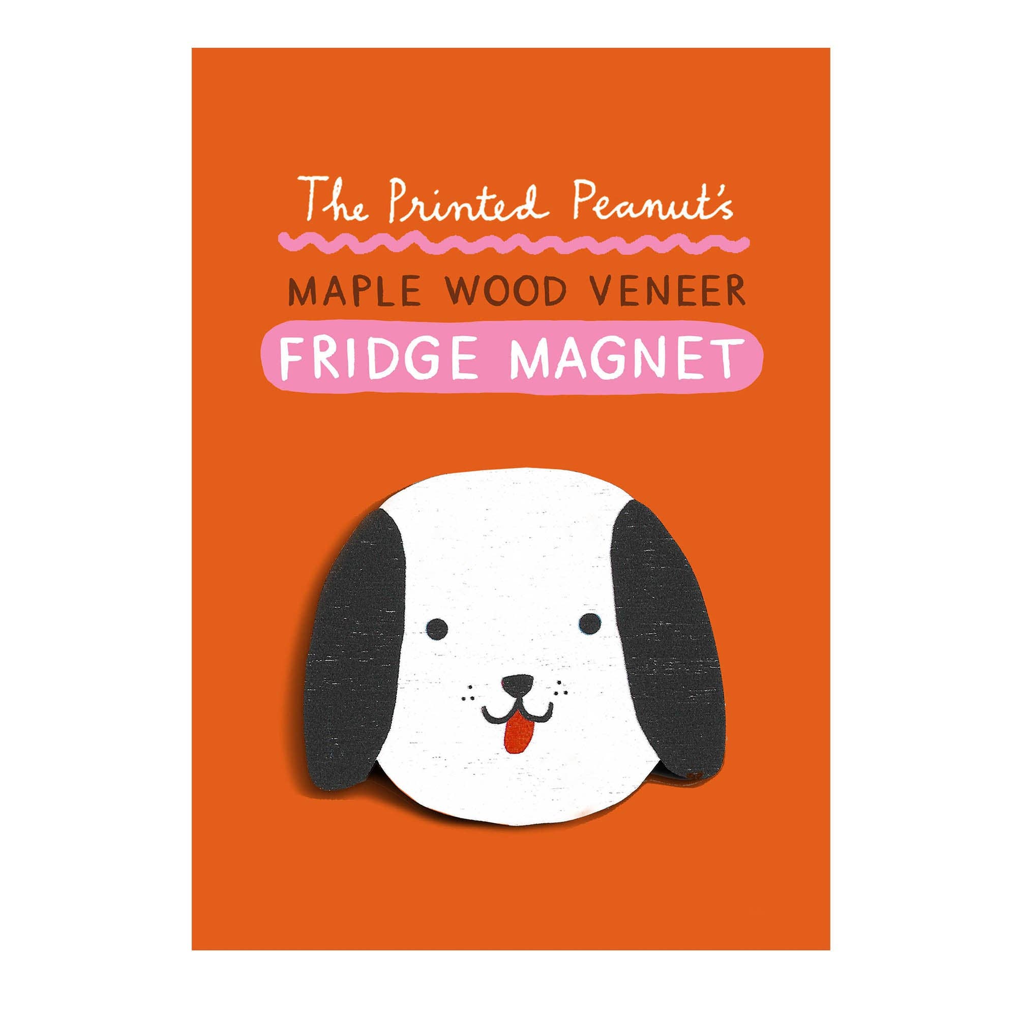 A rectangular orange product card showing a maple wood veneer fridge magnet. The magnet features a cute cartoon dog head with black floppy ears, a white face, and a red tongue.