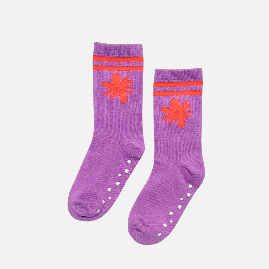 Purple socks with orange flower designs and striped patterns on a white background