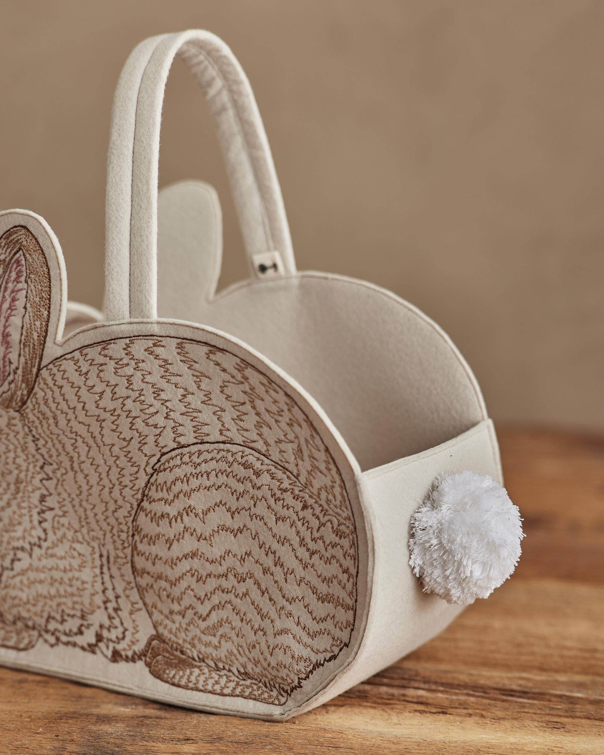 Decorative basket shaped like a mouse with textured design on a wooden surface