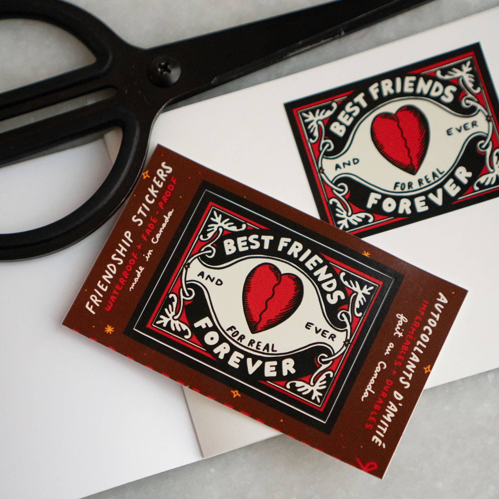 Two 'Best Friends Forever' stickers with a pair of scissors on a white background